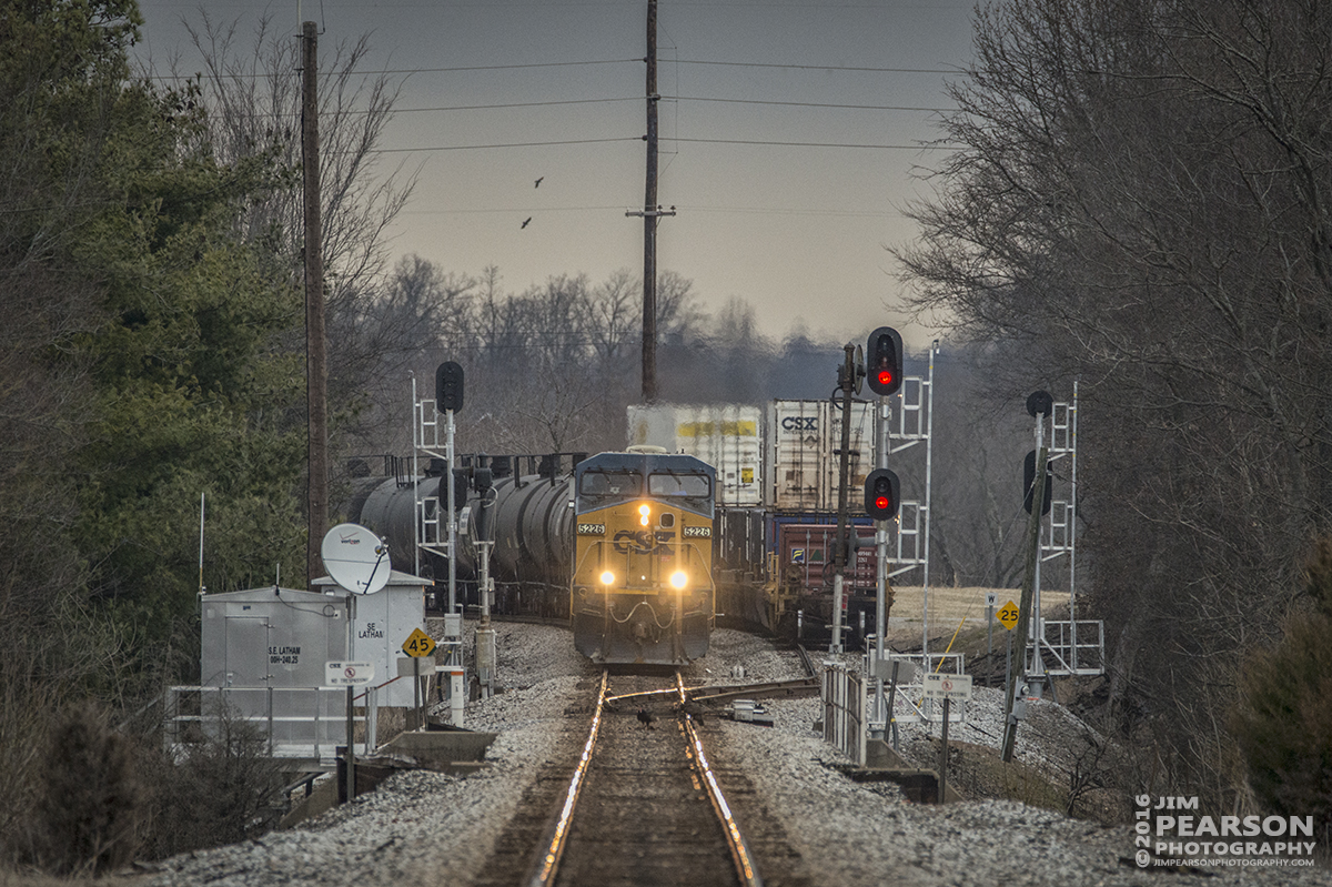 February 19, 2016 - This long lens perspective, shot from a grade crossing, shows CSX ethanol train K447-18 waiting on the main at the south end of Latham siding in Hopkinsville, Ky as intermodal Q102 pulls into the siding on the right to allow the long tank train to pass on it's way south on the Henderson Subdivision. - Tech Info: 1/800 | f/6 | ISO 1600 | Lens: Sigma 150-600 @ 480mm on a Nikon D800 shot and processed in RAW.