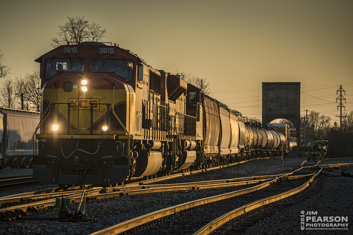 February 27, 2016 - The warm light of the setting sun casts a glow on CSX Q555 as it departs Doyle Yard at Owensboro, Ky as it heads east on the Louisville Division with Kansas City Southern 3915 in the lead. - Tech Info: 1/800 | f/5 | ISO 200 | Lens: Sigma 150-600 @ 180mm with a Nikon D800 shot and processed in RAW.