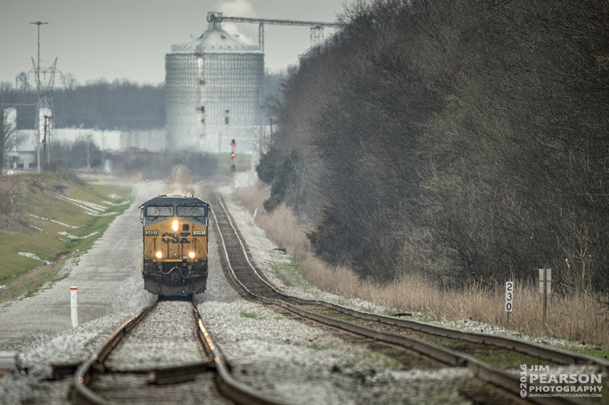 March 12, 2016 - CSXT 5491 leads a loaded grain train up the Casky Yard lead at the south end of Pembroke, Ky as it heads south on the Henderson Subdivision. - Tech Info: 1/1000 | f/6.3 | ISO 400 | Lens: Sigma 150-600 @ 600mm on a Nikon D800 shot and processed in RAW. ?