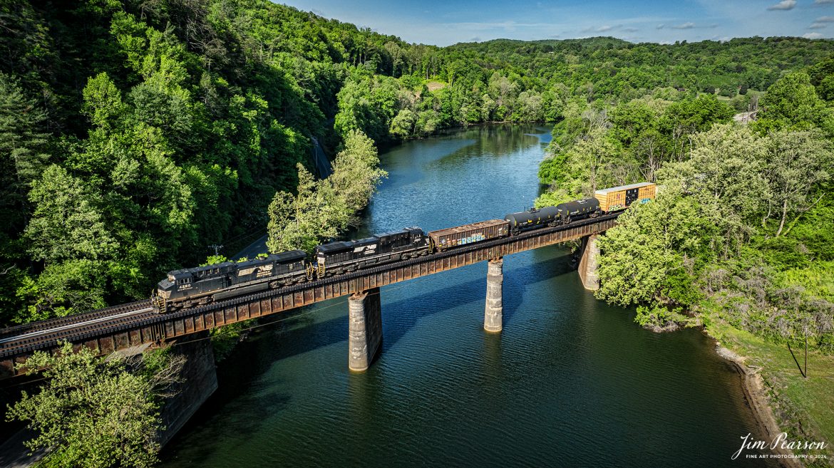 Norfolk Southern 171 crosses the Emory River at Harriman, TN, just south of Harriman Junction, on the NS CNO&TP (Rathole) Second District as it heads south on April 29th, 2024.

According to American-rails.com, It used to be called the Rathole Division when it was the Southern Railway and is often remembered as a road with relatively flat and tangent main lines due to the region in which it operated. However, the system did feature its share of steep, circuitous main lines such as Saluda Grade in western North Carolina and its famed “Rathole Division” through Kentucky and Tennessee that reached as far north as Cincinnati.

Technically, this stretch of the Southern main line was known as the 2nd District of subsidiary Cincinnati, New Orleans & Texas Pacific (CNO&TP), which was plagued for years by numerous tunnels resulting in its famous nickname by the crews which operated over it.

Over the years the Southern worked to daylight or bypass these obstacles as the route saw significant freight tonnage, a task finally completed during the 1960s. Today, the Rathole remains an important artery in Norfolk Southern’s vast network.

Tech Info: DJI Mavic 3 Classic Drone, RAW, 22mm, f/2.8, 1/2000, ISO 140.

#railroad #railroads #train #trains #bestphoto #railroadengines #picturesoftrains #picturesofrailway #bestphotograph #photographyoftrains #trainphotography #JimPearsonPhotography #nscnotpsubdivision #norfolksouthern #trendingphoto