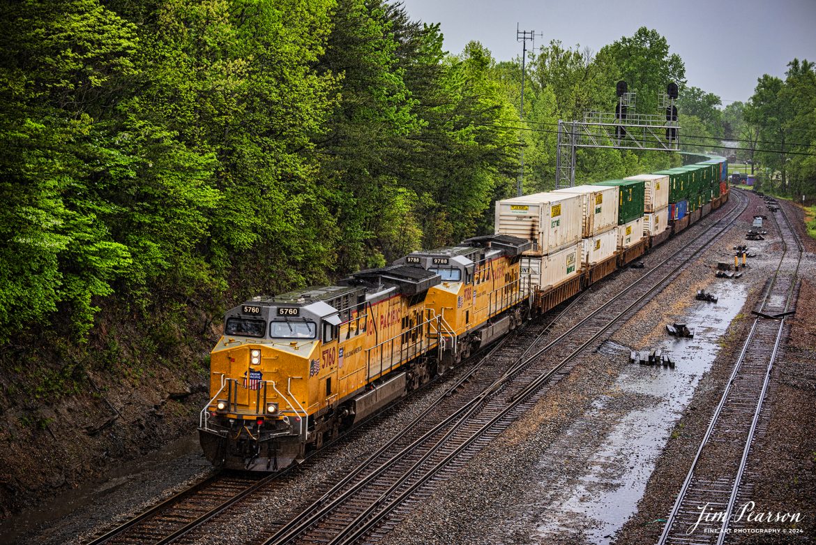 Union Pacific 5760 and 9788 lead Norfolk Southern 224 through the location known as Revilo, at Sterns, Ky, through a light rain as they head northbound on the CNO&TP 2nd District.

According to American-rails.com, It used to be called the Rathole Division when it was the Southern Railway and is often remembered as a road with relatively flat and tangent main lines due to the region in which it operated. However, the system did feature its share of steep, circuitous main lines such as Saluda Grade in western North Carolina and its famed “Rathole Division” through Kentucky and Tennessee that reached as far north as Cincinnati.

Technically, this stretch of the Southern main line was known as the 2nd District of subsidiary Cincinnati, New Orleans & Texas Pacific (CNO&TP), which was plagued for years by numerous tunnels resulting in its famous nickname by the crews which operated over it.

Over the years the Southern worked to daylight or bypass these obstacles as the route saw significant freight tonnage, a task finally completed during the 1960s. Today, the Rathole remains an important artery in Norfolk Southern’s vast network.

Tech Info: Nikon D810, RAW, Sigma 24-70 @ 70mm, f/5, 1/400, ISO 80.

#trainphotography #railroadphotography #trains #railways #trainphotographer #railroadphotographer #jimpearsonphotography #NikonD810 #NorfolkSouthern #UnionPacific