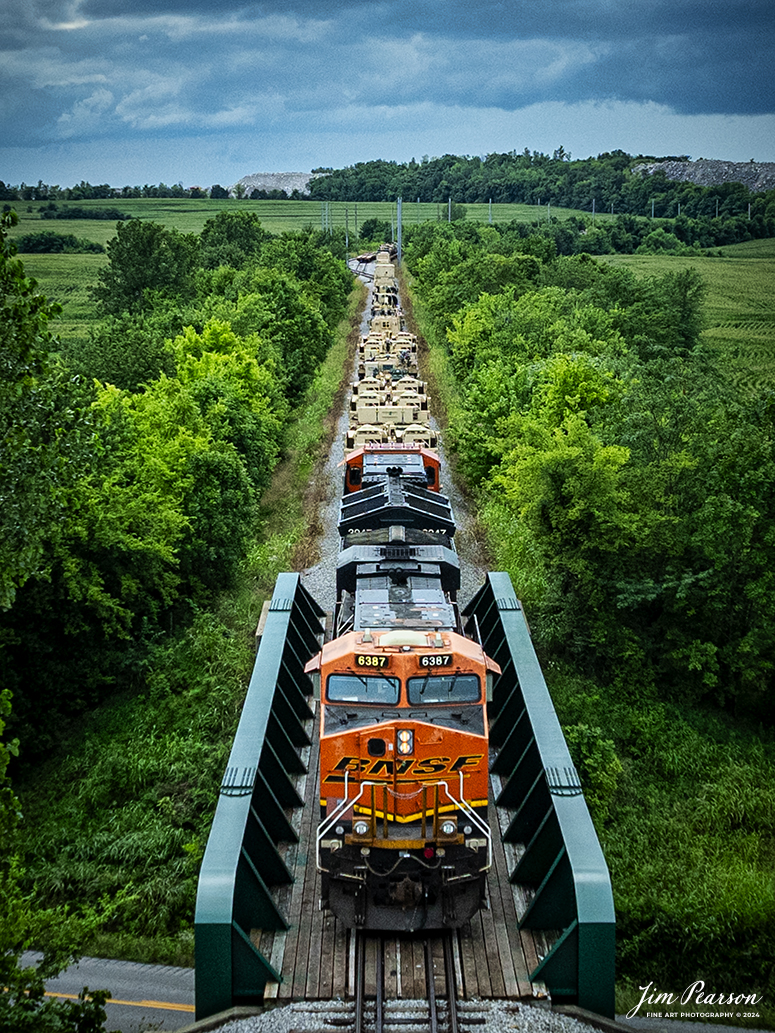 BNSF 6387 and 3947 lead CSX S577 as the crew backs a loaded military train onto the Ft. Campbell lead at Hopkinsville, Ky, from the CSX Henderson Subdivision on July 9th, 2024, under threatening skies during a Tornado Warning spawned by the remnants of Hurricane Alberto. Fellow railfan Brian Caswell and I sat for a couple hours hoping that Ft. Campbell would show up to carry the equipment onto the base, but unfortunately it didn’t happen. Despite the warnings here very little rain fell and most of the tornados spawned in our area were more to the northeast up in Indiana.

Tech Info: DJI Mavic 3 Classic Drone, RAW, 22mm, f/2.8, 1/1000, ISO 200.

#railroad #railroads #train #trains #bestphoto #railroadengines #picturesoftrains #picturesofrailway #bestphotograph #photographyoftrains #trainphotography #JimPearsonPhotography #trendingphoto #militarytrains #stormyweather