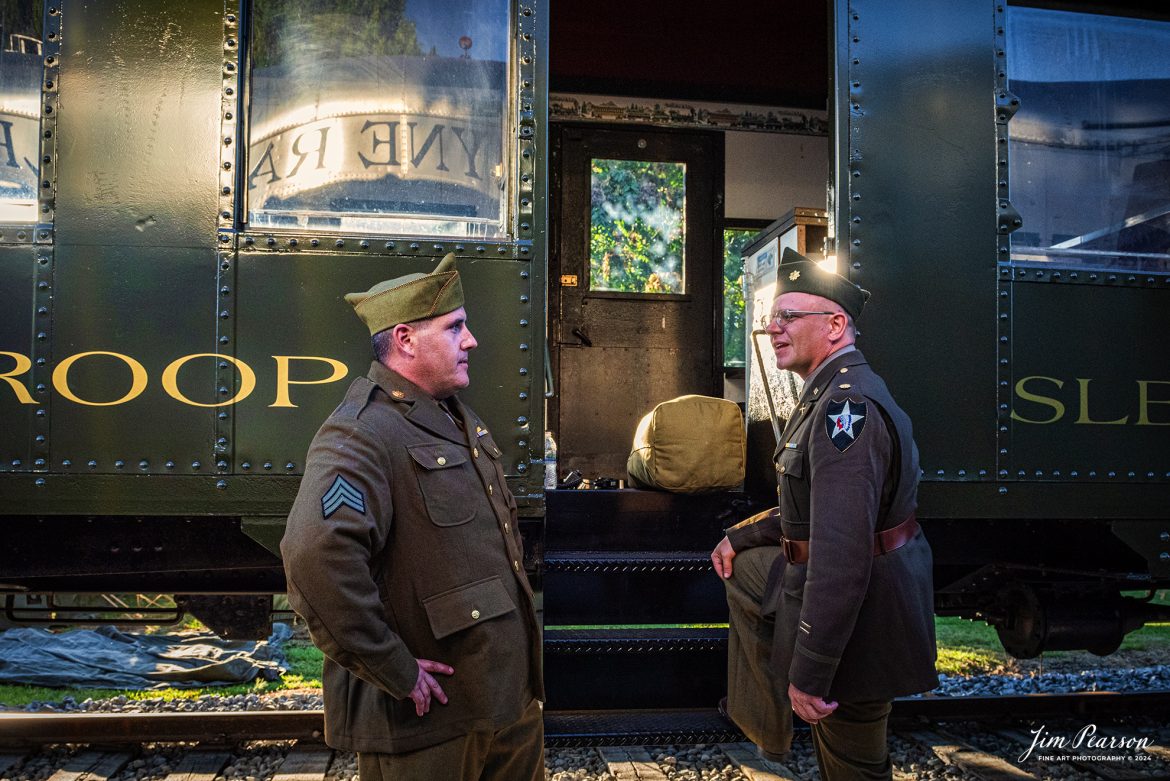 Military reenactors Chris Lantz and Matt Martini chat at the entrance to a Troop Sleeper during the NKP 765 evening/night photo shoot at Pleasant Lake, IN, on August 31st, 2024, as part of the Rolling Victory Weekend.

According to their website: Rolling Victory was a three-day living history event celebrating American military, railroad, and home front history featuring vintage train rides, World War II reenactors, battles, a big band orchestra, and an immersive and educational experience for all ages in Pleasant Lake, Indiana.

Tech Info: Nikon D810, RAW, Nikon 24-70 @ 24mm, f/6.3, 1/640, ISO 2200.

#railroad #railroads #train, #trains #railway #railway #steamtrains #railtransport #railroadengines #picturesoftrains #picturesofrailways #besttrainphotograph #bestphoto #photographyoftrains #bestsoldpicture #JimPearsonPhotography #steamtrains #nkp765 #passengertrains