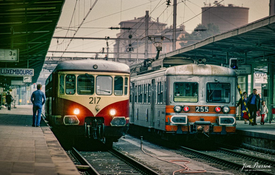 A hazy day shrouds the day as engines 217 and 255 and the rest of their trains sit in the Luxembourg main train station as passengers mill about on the platforms in this 1981 photo where I changed trains on one of my many trips around Europe from 1978-1981 when I lived outside Frankfurt, West Germany.

According to Wikipedia: Luxembourg railway station is the main railway station serving Luxembourg City, in southern Luxembourg. It is operated by Chemins de Fer Luxembourgeois, the state-owned railway company and 80,000 passengers use this station every day.

It is the hub of Luxembourg's domestic railway network, serving as a point of call on all of Luxembourg's railway lines. It also functions as the country's international railway hub, with services to all the surrounding countries: Belgium, France, and Germany. Since June 2007, the LGV Est connects the station to the French TGV network.

Tech Info: Nikon F3, Kodachrome Slide

#trainphotography #railroadphotography #trains #railways #jimpearsonphotography #trainphotographer #railroadphotographer #Luxembourg #trainstation