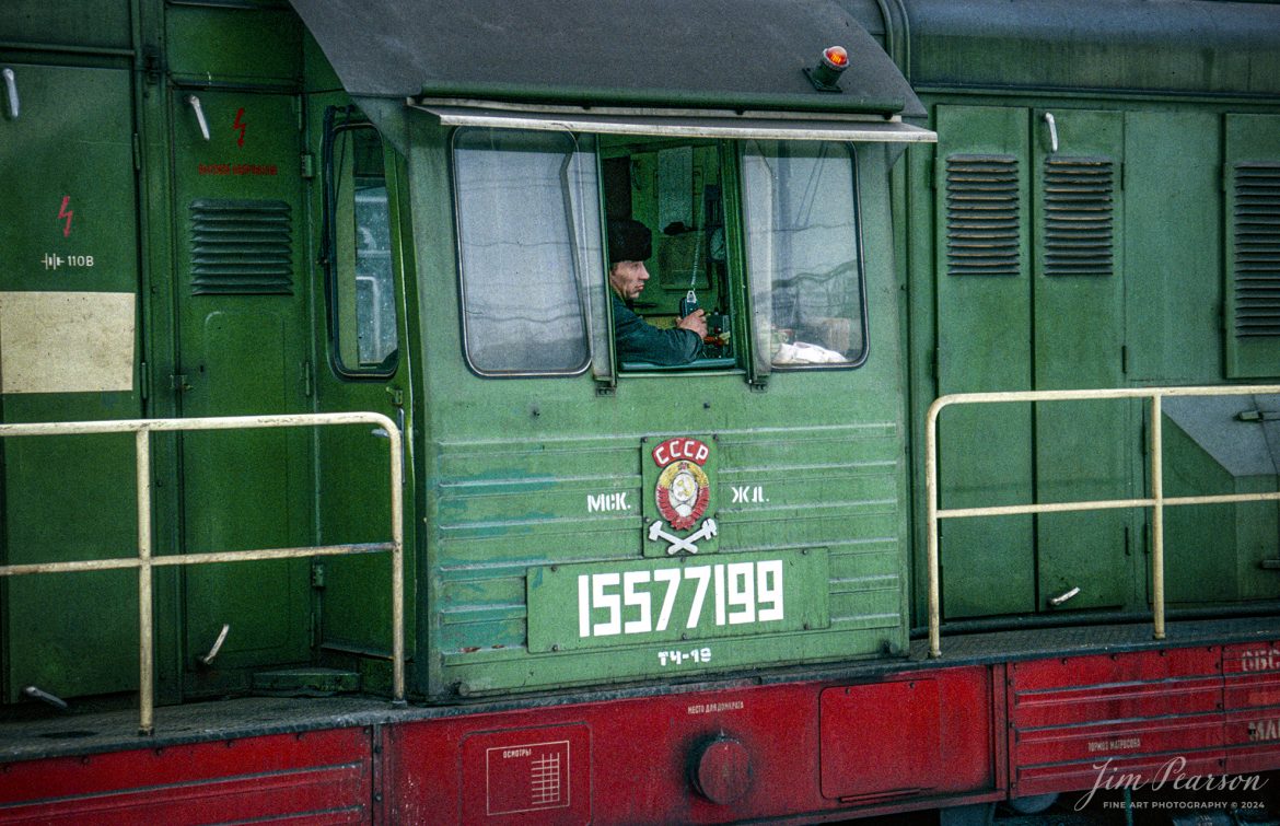 The engineer on Russian Diesel locomotive 15577199 waits for permission to depart from the yards at Moscow, Russia sometime during the winter months of 1992. This image is from a slide scan that I shot while I was taking part in a military humanitarian called Provide Hope.

For awhile I was the non-commissioned officer in charge of the Air Force’s Electronic Imaging Center stationed at Aviano, Italy, where Combat Camera was tasked to document the Provide Hope operation. I was there for six months, and we flew missions in and out of the USSR. This was on one trip to Moscow where we spent a couple days in the country, documenting the delivery of supplies to an orphanage. Of course, during my off time, I made sure to visit the train station that was just outside our hotel! 

According to Wikipedia:  Operation Provide Hope was a humanitarian operation conducted by the U.S. Air Force to provide medical equipment to former Soviet republics during their transition to capitalism. The operation was announced by Secretary of State James A. Baker, III on January 22–23, 1992 and the initial shipment of supplies was sent on February 10, 1992. Twelve US Air Force C-5 and C-141 was carrying an estimated 500 tons of bulk-food rations and medicines into Moscow, St. Petersburg, Kyiv, Minsk, and Chisinau from Germany and Yerevan, Almaty, Dushanbe, Ashkhabad, Baku, Tashkent, and Bishkek from Turkey. In total, for nearly two weeks sixty-five missions flew 2,363 short tons (2,144 t) of food and medical supplies to 24 locations in the Commonwealth of Independent States during the initial phase of operation. Much of these supplies was left over from the buildup to the Persian Gulf War.

Small teams of US personnel from various government agencies (On-Site Inspection Agency, USAID, and USDA) had been placed in each destination shortly before the deliveries, to coordinate with local officials and to monitor to the best extent possible that the deliveries reached the intended recipients (i.e., orphanages, hospitals, soup kitchens, and needy families).

Tech Info: Nikon F3, Kodachrome Slide

#trainphotography #railroadphotography #trains #railways #jimpearsonphotography #trainphotographer #railroadphotographer #Russia #Moscow