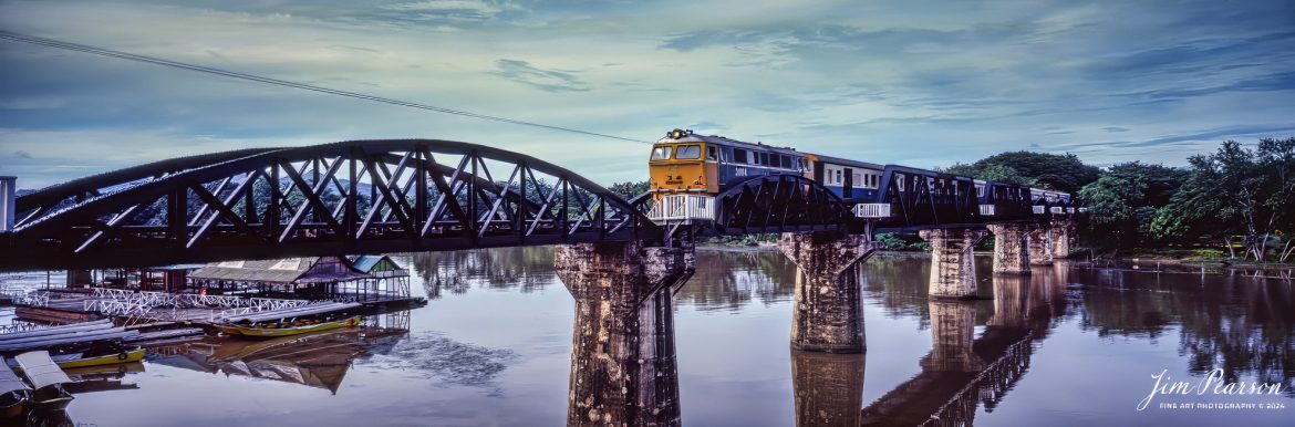 The State Railway of Thailand (SRT) locomotive 3004 heads across the Bridge over the River Kwai, around 1988, as it heads to the Kanchanaburi Station on part of the original 258-mile (415-kilometer) long Thai-Burma Railway. 

During WW II, Japan constructed this meter-gauge railway line from Ban Pong, Thailand to Thanbyuzayat, Burma. The line passing through the scenic Three Pagodas Pass runs for 250 miles. This is now known as the Death Railway.

The railway line was meant to transport cargo daily to India, to back up their planned attack on India. The construction was done using POWs and Asian slave laborers in unfavorable conditions. The work started in October 1942 and was completed in a year. Due to the difficult terrain, thousands of laborers lost their lives. It is believed that one life was lost for each sleeper (tie) laid in the track.

At the nearby Kanchanaburi War Cemetery, around 7,000 POWs, who sacrificed their lives in the railway construction, are buried. Another 2,000 are laid to rest at the Chungkai Cemetery.

The River Kwai Bridge became famous all over the world, when it was featured in movies and books. The cliff-hugging tracks and the natural beauty of the surrounding mountains and valleys were well captured in the David Lean movie.

This is another scan from a Fuji 6x17 film camera that I’ve shot in the past and on Saturday’s at 5pm CST I plan on highlighting some of these images and others shot on slide film, so check back then to see more images from around the world from my past travels!

Fuji 6x17, Fuji 105mm lens, other exposure information wasn’t recorded back then, shot on Kodachrome Film.

#trainphotography #railroadphotography #trains #railways #jimpearsonphotography #panphotography #6x17photography #trainphotographer #railroadphotographer #Thailand #deathrailway