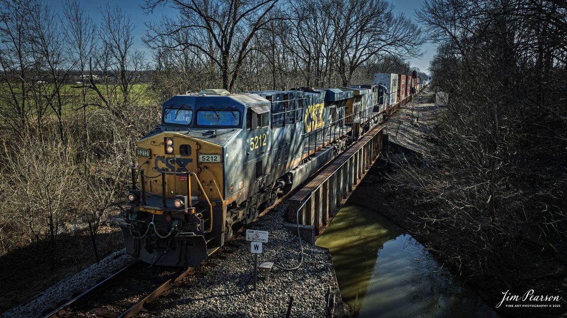 CSXT 5212 leads northbound hot intermodal I026 as it crosses over White Creek, at the north end of the Latham siding at Hopkinsville, Ky, on February 3rd, 2025, on the CSX Henderson Subdivision.

Tech Info: DJI Mavic 3 Classic Drone, RAW, 24mm, f/2.8, 1/1250, ISO 310.

#railroad #railroads #train, #trains #railway #railway #railtransport #railroadengines #picturesoftrains #picturesofrailways #besttrainphotograph #bestphoto #photographyoftrains #bestsoldpicture #JimPearsonPhotography #trainsfromadrone