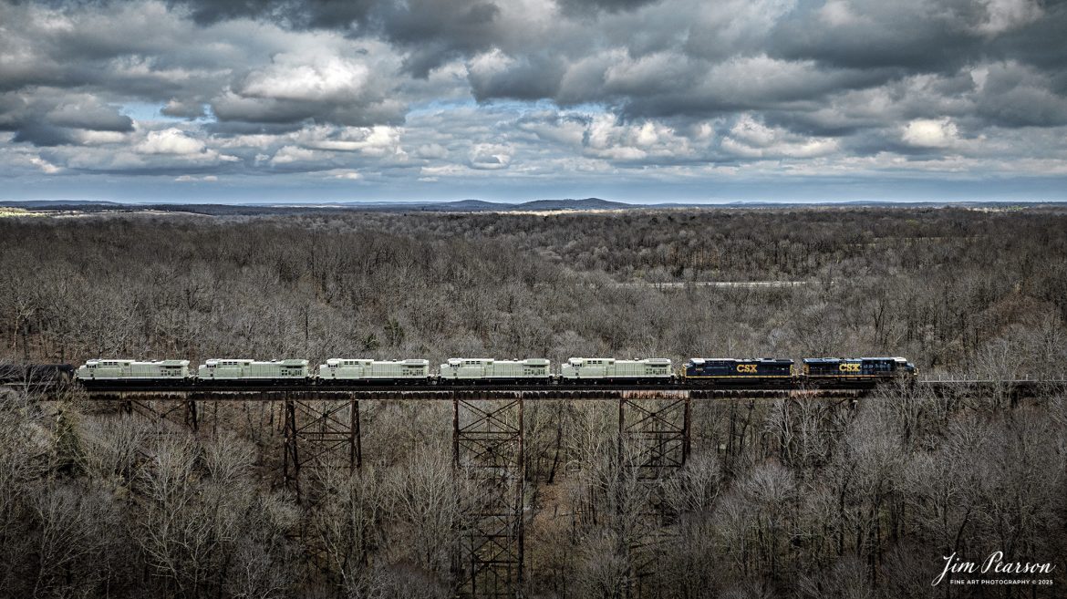 CSX M813 heads across the Gum Lick trestle just north of Kelly, Kentucky, with engines FEX 4937, 4936, 4934, 4939, 4938 in tow as they head south on the CSX Henderson Subdivision on March 16th, 2025. The locomotives in tow were FEX 4937, 4936, 4934, 4939, 4938 and they’re bound for the Ferromex Railroad.

Ferromex (reporting mark FXE) (syllabic abbreviation of Ferrocarril Mexicano, 'Mexican Railway') is a private rail consortium that operates the largest (by mileage) railway in Mexico with combined mileage (Ferromex + Ferrosur) of 12,100 kilometres (7,500 mi) and is often classed with North American Class I railroads.

Ferromex began operating on February 19, 1998, following the privatization of most of the government-owned railways by Mexican President Ernesto Zedillo Ponce de León. Ferromex operates more than 9,610 kilometers (5,970 mi) of track and interconnects five major inland Mexican cities, five cities along the border with the United States, four seaports on the Pacific Ocean, and one more on the Gulf of Mexico. Grupo México owns 74% and Union Pacific Corporation owns 26% of the company. The Ferromex system operates 9,610 km of Ferromex tracks plus 2,654 kilometers (1,649 mi) of Ferrosur tracks.

Tech Info: DJI Mavic 3 Classic Drone, RAW, 22mm, f/2.8, 1/1600, ISO 160.

#railroad #railroads #train, #trains #railway #railway #railtransport #railroadengines #picturesoftrains #picturesofrailways #besttrainphotograph #bestphoto #photographyoftrains #bestsoldpicture #JimPearsonPhotography #trainsfromadrone #csxhendersonsubdivision #onecsx #Ferromex