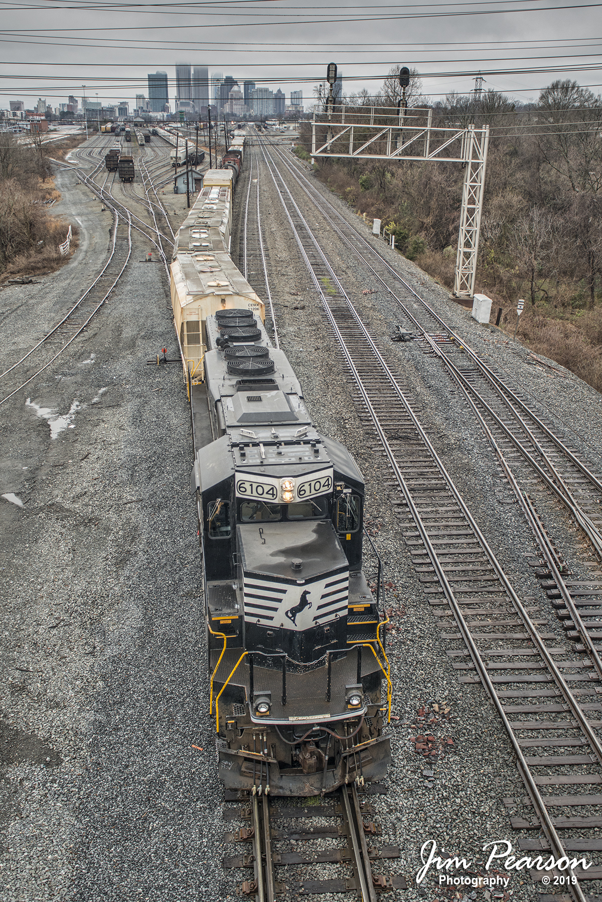 January 13, 2019 - NS 6104 leads a mixed freight as it works the north end of Charlotte Yard at Charlotte, NC as it builds a train with the city skyline in the background on a wet and dreary day. - #jimstrainphotos #northcarolinarailroads #trains #nikond800 #railroad #railroads #train #railways #railway #NC #NCrailroads