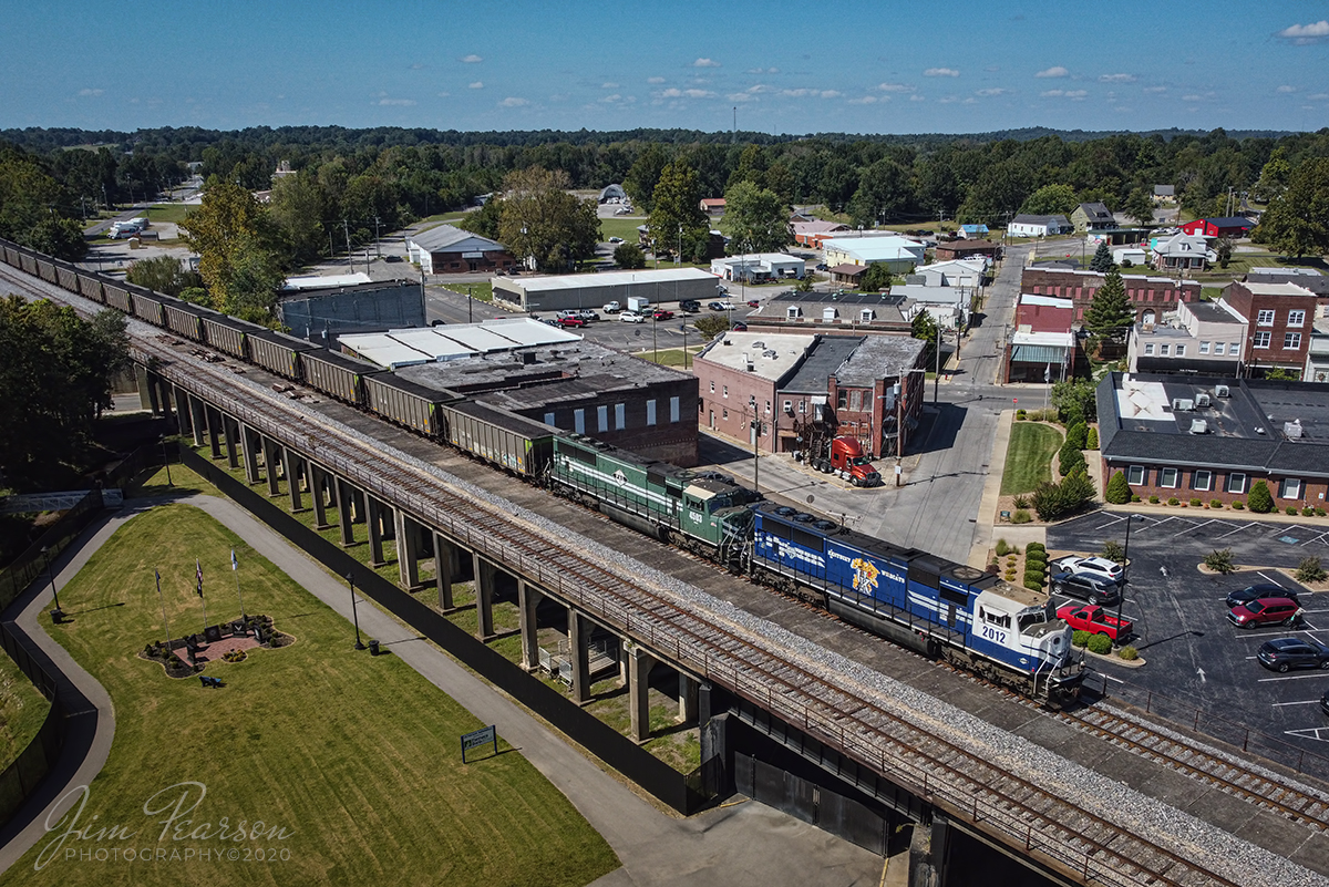 September 21, 2020 - Paducah and Louisville Railway University of Kentucky locomotive 2012 leads the afternoon Louisville Gas and Electric coal train as it skirts the downtown area of Central City, Kentucky on its way north to Louisville.

The grassy area below is the general location of the old Illinois Central depot from the days when passenger trains used to service Central City. There used to be an elevator that took the passengers up to the tracks to catch their trains. 

Tech Info: DJI Mavic Mini Drone, JPG, 4.5mm (24mm equivalent lens) f/2.8, 1/1250, ISO 100.