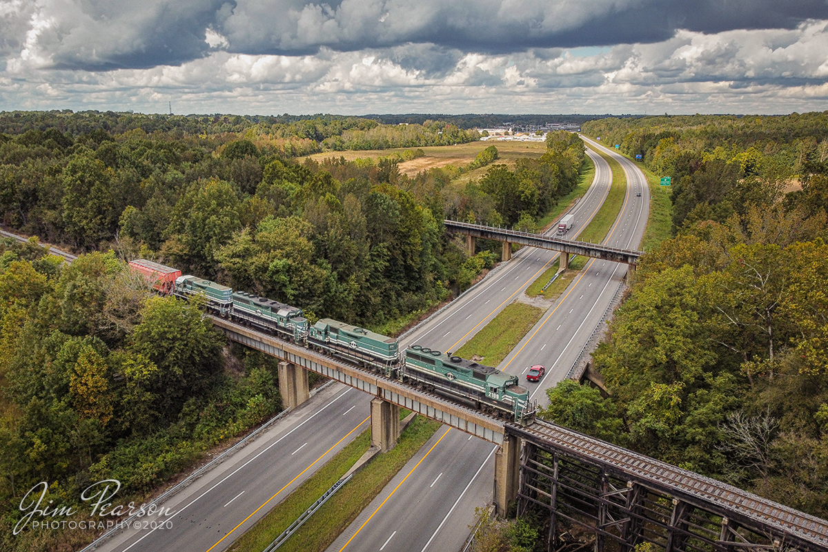 September 29, 2020 - Paducah and Louisville Railway (PAL) 2109, 2110, 2117 and 2120 lead local WW1 across Interstate 69 at Madisonville, Kentucky as they head to CSX's Atkinson yard with a lone car today for interchange with CSX. From here they will take the junction trackage called East Diamond and head back across the other bridge in the background to Atkinson at Madisonville where they dropped the car and picked up a much longer string of cars for the return trip to Princeton, Ky. 

PAL runs this local pretty much M-S from Princeton to Madisonville and there's another local that runs from Paducah to Princeton to move traffic between those cities with pretty much the same schedule. There's also another local that runs from Louisville to Paducah and back, but it is normally a night run in both directions. Occasionally I see these trains run also on Sunday, but it's not the norm.

Tech Info: DJI Mavic Mini Drone, JPG, 4.5mm (24mm equivalent lens) f/2.8, 1/800, ISO 200.