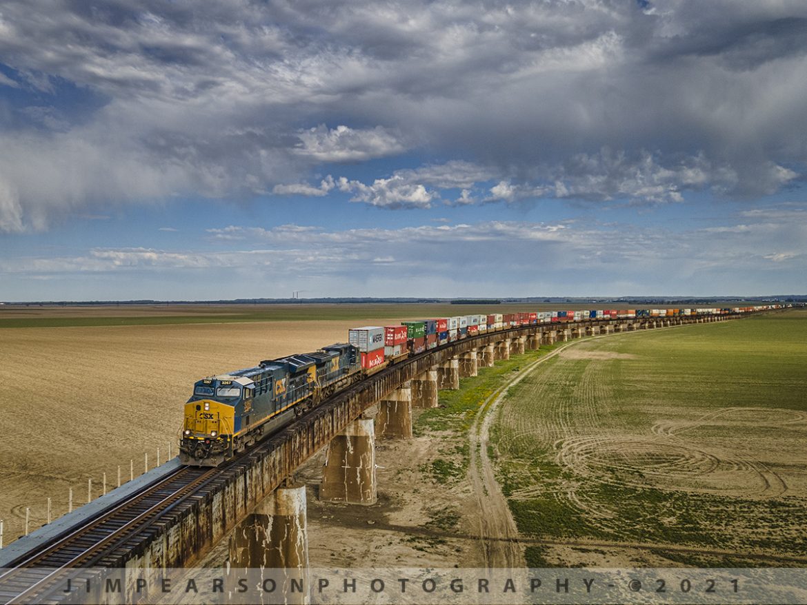 CSX Q025 Southbound up the viaduct at Rahm, Indiana

On March 10th, 2021 I posted a shot of CSX Q025 (Bedford Park, IL - Jacksonville, FL) as it made its way up this viaduct at Rahm, Indiana while all the land here was covered with floodwaters. 

Many folks asked for a shot along the same viewpoint after the floodwaters receded back into the Ohio River and so here the shot a month later! On April 9th, 2021 CSX Q025 approaches the bridge over the Ohio river between Rahm, IN and Henderson, Ky as it makes its way south on the CSX Henderson Subdivision on a breathtaking spring day!

From the Web: The current viaduct and bridge were built by the L&N railroad and were dedicated on the last day of 1932 at a cost about $4 million. It replaced one erected in 1885, also built by the L&N, which at that time was the longest channel span of that type in the world at 2.3 miles long.

Tech Info: DJI Mavic Air 2 Drone, RAW, 4.5mm (24mm equivalent lens) f/2.8, 1/640, ISO 100.