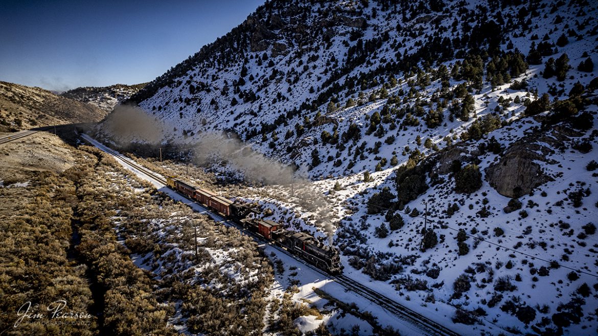 I've been wanting to visit the Nevada Northern Railway for several years now and finally was able to do so during the Winter Steam Charter over the weekend of February 11-13th, 2022. I had a great trip and although drones werent allowed during the photo runbys, we chased by car on Sunday afternoon so we could grab some aerials as the train was moving between runby locations in Robinson Canyon. 


Here we see Nevada Northern Railway steam locomotive #91 pulling a work train southbound through the Canyon out of Ely, Nevada as the light begins to fall behind the mountains on February 13th, 2022.


According to Wikipedia: "The Nevada Northern Railway Museum is a railroad museum and heritage railroad located in Ely, Nevada and operated by a historic foundation dedicated to the preservation of the Nevada Northern Railway.


The museum is situated at the East Ely Yards, which are part of the Nevada Northern Railway. The site is listed on the United States National Register of Historic Places as the Nevada Northern Railway East Ely Yards and Shops and is also known as the "Nevada Northern Railway Complex". The rail yards were designated a National Historic Landmark District on September 27, 2006. The site was cited as one of the best-preserved early 20th-century railroad yards in the nation, and a key component in the growth of the region's copper mining industry. Developed in the first decade of the 20th century, it served passengers and freight until 1983, when the Kennecott Copper Company, its then-owner, donated the yard to a local non-profit for preservation. The property came complete with all the company records of the Nevada Northern from its inception."

Engine #93 is a 2-8-0 that was built by the American Locomotive Company in January of 1909 at a cost of $17,610. It was the last steam locomotive to retire from original revenue service on the Nevada Northern Railway in 1961 and was restored to service in 1993.


Tech Info: DJI Mavic Air 2 Drone, RAW, 4.5mm (24mm equivalent lens) f/2.8, 1/2000, ISO 100.


#trainphotography #railroadphotography #trains #railways #jimpearsonphotography #trainphotographer #railroadphotographer