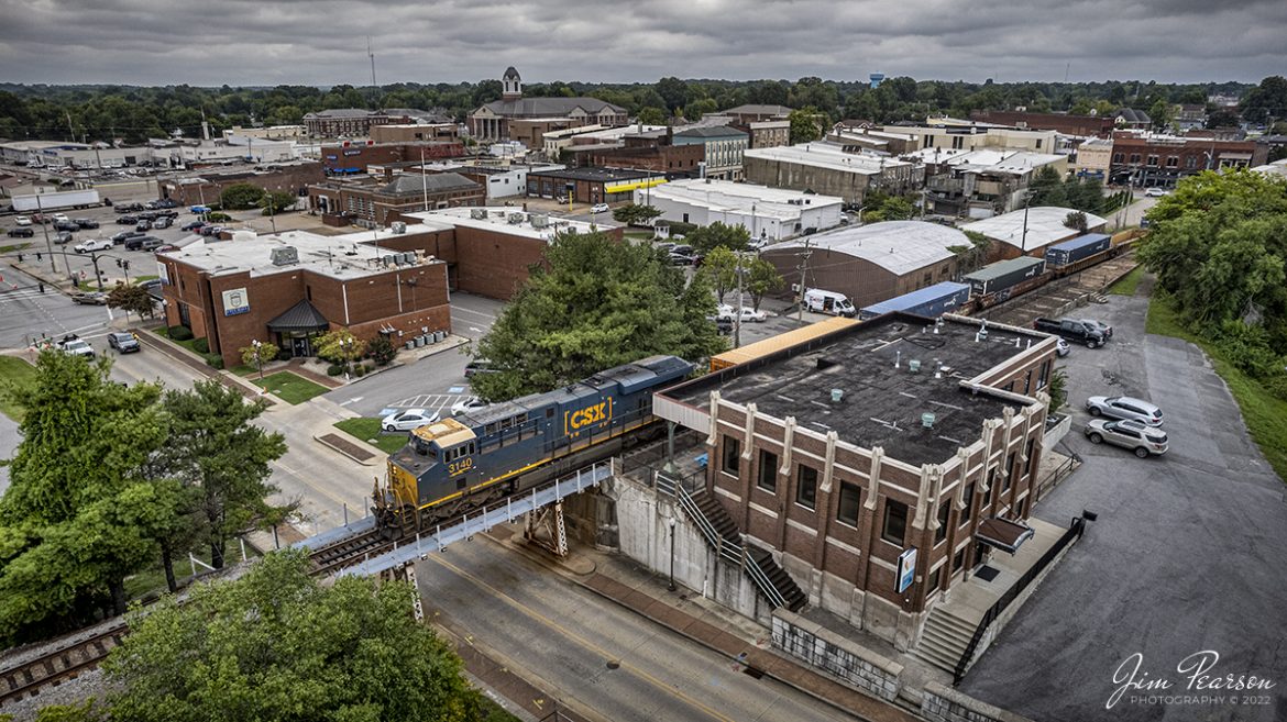 CSX intermodal I028 passes the old Louisville and Nashville Railroad Depot in downtown Madisonville, Kentucky as it heads north on the CSX Henderson Subdivision on September 6th, 2022.

This depot was originally dedicated in 1929 and last saw passenger service about 1968 when L&N built a yard office at Atkinson Yard in Madisonville and the passenger train service was moved to that location. Currently the station is owned by the city of Madisonville and houses one of the hubs of the Kentucky Innovation Stations, which helps encourage entrepreneurs, creative business founders, high-growth startups, and savvy investors star in their own success stories.

Tech Info: DJI Mavic Air 2 Drone, RAW, 4.5mm (24mm equivalent lens) f/2.8, 1/1250, ISO 150.

#trainphotography #railroadphotography #trains #railways #dronephotography #trainphotographer #railroadphotographer #jimpearsonphotography