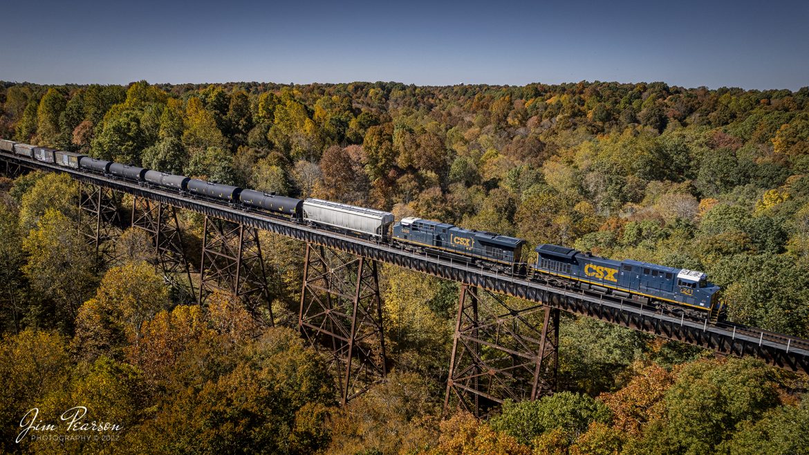 With fall color ablaze, CSX M648 heads north across Gum Lick Trestle with CSXT 7241 and 5408 leading, just north of Robards, Kentucky on October 17th, 2022, on the Henderson Subdivision. This train runs between Rice Yard at Waycross, GA and Clearing Yard at Chicago, IL

Tech Info: DJI Mavic Air 2S Drone, 22mm, f/2.8, 1/1500, ISO 130.

#trainphotography #railroadphotography #trains #railways #dronephotography #trainphotographer #railroadphotographer #jimpearsonphotography #csxhendersonsubdivision #trainsfromtheair #kentuckytrains