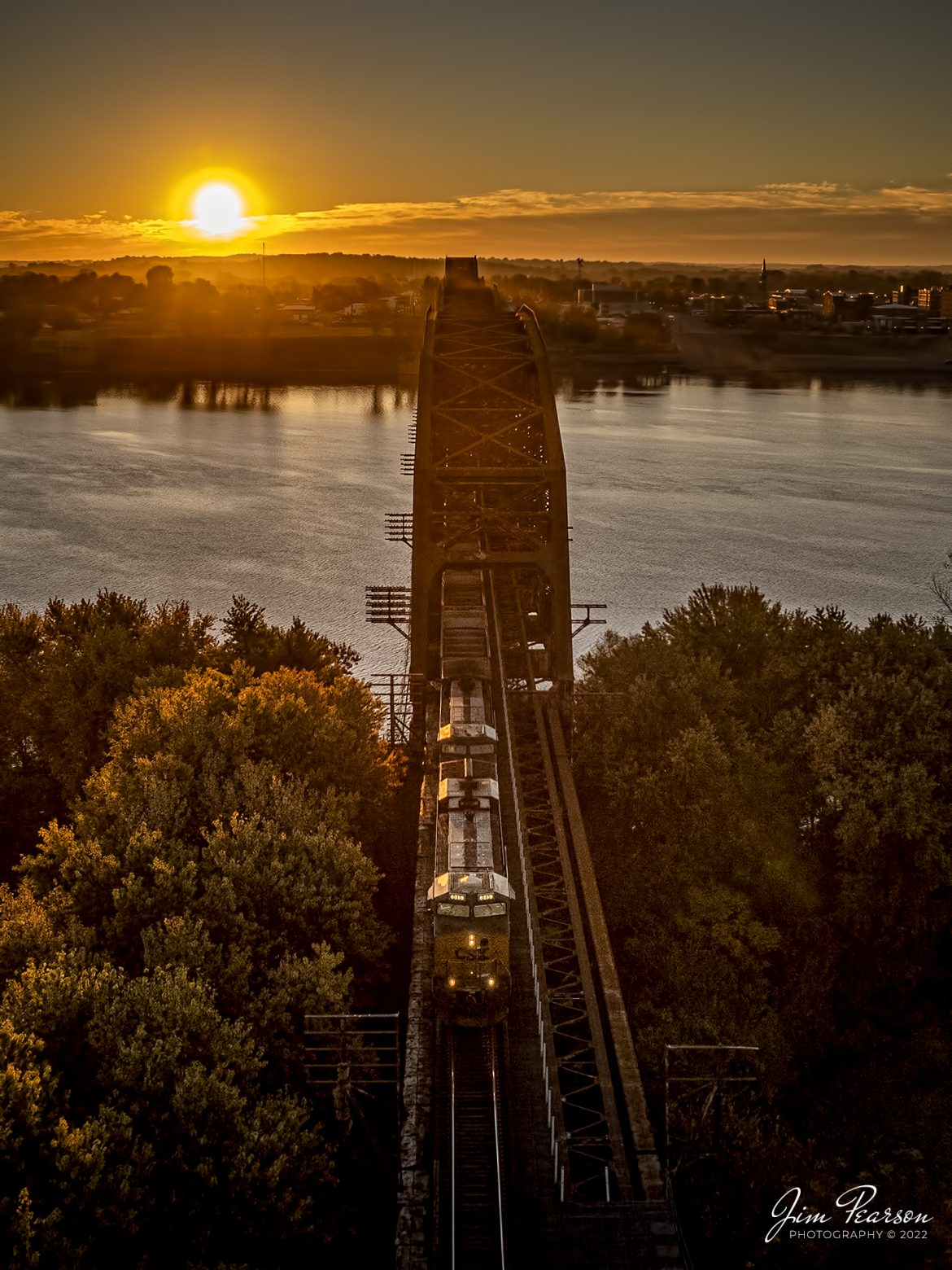 CSXT 845 leads E302 northbound as it exits the bridge over the Ohio River at sunrise, from Henderson, Kentucky, on October 28th, 2022, on the Henderson Subdivision. This train runs between Stilesboro, GA (Plant Bowen) and Sugar Camp Mine on the Evansville Western Railway.

Tech Info: DJI Mavic Air 2S Drone, RAW, 22mm, f/2.8, 1/2000, ISO 100 -1.7stops.

#trainphotography #railroadphotography #trains #railways #dronephotography #trainphotographer #railroadphotographer #jimpearsonphotography