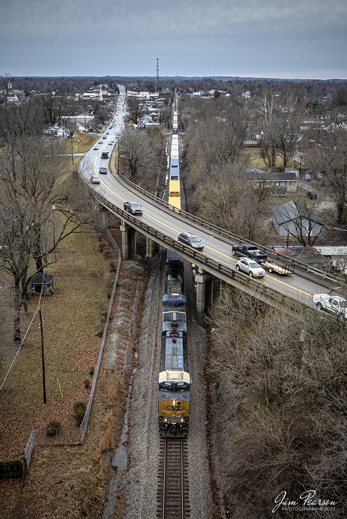 CSXT 866 leads a short I026 intermodal (Duval Yard - Jacksonville, FL to Bedford Park, IL) under the North Main Street overpass on January 3rd, 2023, as it heads north on the Henderson Subdivision at Madisonville, Kentucky.

Tech Info: DJI Mavic Air 2S Drone, 22mm, f/2.8, 1/500, ISO 100.

#trainphotography #railroadphotography #trains #railways #dronephotography #trainphotographer #railroadphotographer #jimpearsonphotography #trainsfromtheair #trainsfromadrone #csx #csxhendersonsubdivision