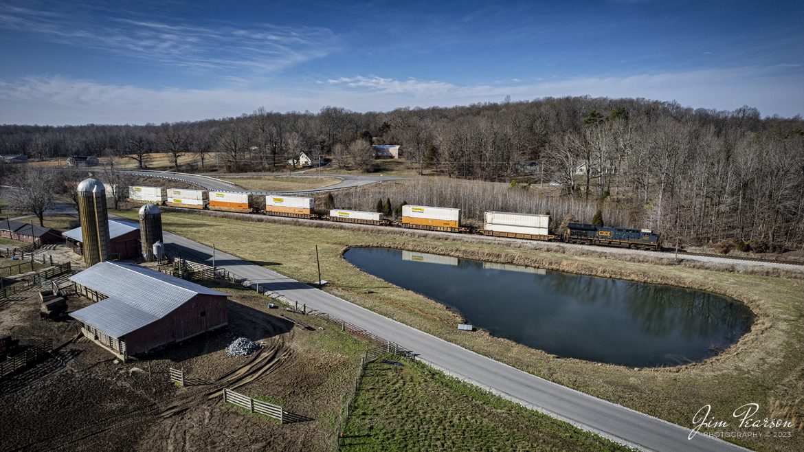 CSXT 3304 leads I028 (Duval Yard - Jacksonville, FL, to Bedford Park, IL) northbound at the location known as Poorhouse on the Henderson Subdivision at Madisonville, Kentucky, on January 24th, 2023, as they make their way past a small farming operation on a beautiful winter day. This location is called Poorhouse as it was named by the Louisville and Nashville Railroad and used to be close to the Hopkins County Poorhouse that operated in the early 1900s. It has retained its name since then.

Tech Info: DJI Mavic Air 2S Drone, RAW, 22mm, f/2.8, 1/1600, ISO 120.

#trainphotography #railroadphotography #trains #railways #dronephotography #trainphotographer #railroadphotographer #jimpearsonphotography #trainsfromtheair #csxhendersonsubdivision #kentuckytrains