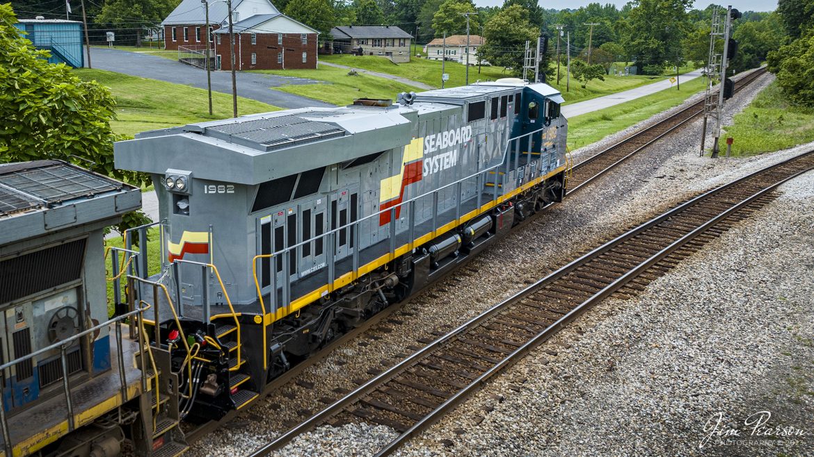 CSX Heritage series locomotive 1982, the Seaboard System unit, heads north through Mortons Junction at Mortons Gap, Kentucky, as it leads CSX I026 northbound on the Henderson Subdivision on July 4th, 2023. 

According to Wikipedia: The Seaboard System Railroad, Inc. (reporting mark SBD) was a US Class I railroad that operated from 1982 to 1986.

Since the late 1960s, Seaboard Coast Line Industries had operated the Seaboard Coast Line and its sister railroadsnotably the Louisville & Nashville and Clinchfieldas the "Family Lines System". In 1980, SCLI merged with the Chessie System to create the holding company CSX Corporation; two years later, CSX merged the Family Lines railroads to create the Seaboard System Railroad.

In 1986, Seaboard renamed itself CSX Transportation, which absorbed the Chessie System's two major railroads the following year.

Tech Info: DJI Mavic 3 Classic Drone, RAW, 24mm, f/2.8, 1/1600, ISO 140.

#trainphotography #railroadphotography #trains #railways #dronephotography #trainphotographer #railroadphotographer #jimpearsonphotography #trains #csxt #mavic3classic #drones #trainsfromtheair #trainsfromadrone #CSXHeritageUnits