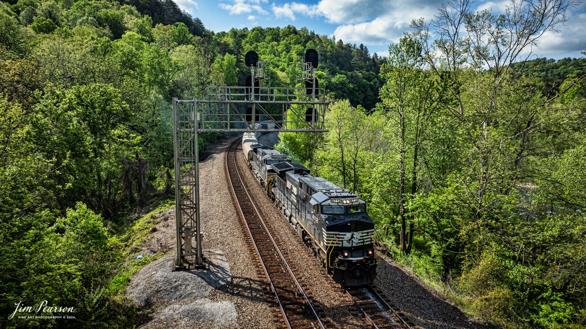 Norfolk Southern 49R departs northbound from Camp Austin at Oakdale, TN, on the NS CNO&TP (Rathole) Second District on April 29th, 2024.

According to American-rails.com, It used to be called the Rathole Division when it was the Southern Railway and is often remembered as a road with relatively flat and tangent main lines due to the region in which it operated. However, the system did feature its share of steep, circuitous main lines such as Saluda Grade in western North Carolina and its famed “Rathole Division” through Kentucky and Tennessee that reached as far north as Cincinnati.

Technically, this stretch of the Southern main line was known as the 2nd District of subsidiary Cincinnati, New Orleans & Texas Pacific (CNO&TP), which was plagued for years by numerous tunnels resulting in its famous nickname by the crews which operated over it.

Over the years the Southern worked to daylight or bypass these obstacles as the route saw significant freight tonnage, a task finally completed during the 1960s. Today, the Rathole remains an important artery in Norfolk Southern’s vast network.

Tech Info: DJI Mavic 3 Classic Drone, RAW, 22mm, f/2.8, 1/2500, ISO 120.

#railroad #railroads #train #trains #bestphoto #railroadengines #picturesoftrains #picturesofrailway #bestphotograph #photographyoftrains #trainphotography #JimPearsonPhotography #nscnotpsubdivision #norfolksouthern #trendingphoto