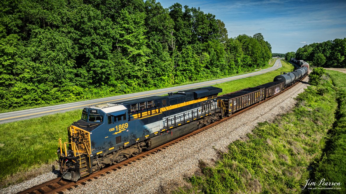 CSXT 1869, Chesapeake & Ohio, heads north as the lead engine on X512 at Sebree, Kentucky on May 12th, 2024, on the CSX Henderson Subdivision. 

From a CSX Press Release: A locomotive commemorating the proud history of the Chesapeake and Ohio Railway has entered service as the fifth in the CSX heritage series celebrating the lines that came together to form the modern railroad.
 
Numbered CSX 1869 in honor of the year the C&O was formed in Virginia from several smaller railroads, the newest heritage locomotive sports a custom paint design that includes today’s CSX colors on the front of the engine and transitions to a paint scheme inspired by 1960s era C&O locomotives on the rear two-thirds.

The C&O Railway was a major line among North American freight and passenger railroads for nearly a century before becoming part of the Chessie System in 1972 and eventually merging into the modern CSX. In 1970, the C&O included more than 5,000 route miles of track stretching from Newport News, Virginia, to Chicago and the Great Lakes. 

Tech Info: DJI Mavic 3 Classic Drone, RAW, 22mm, f/2.8, 1/1250, ISO 100.

#railroad #railroads #train #trains #bestphoto #railroadengines #picturesoftrains #picturesofrailway #bestphotograph #photographyoftrains #trainphotography #JimPearsonPhotography #trendingphoto #csxheritageunit