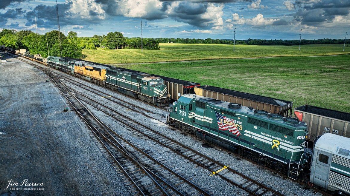 It’s fairly rare to find a military train move on the Paducah and Louisville Railway (PAL) through my neck of the woods, but it does happen. I got word from a friend, Lee Taylor, up the line about an 8,100ft loaded military train that was headed southbound from Ft. Knox, Kentucky. 

I caught up with the train and chased it south to Kentucky Dam from West Yard in Madisonville, Kentucky where they had a crew change, on May 17th, 2024.

As luck would have it, I found the PAL Salute to our Troops engine 2127 sitting in the yard at Princeton, Ky as the southbound military train passed it headed for Paducah, Ky. PAL 2127 was one end of an Operation Lifesaver Trainset that was there.

Tech Info: DJI Mavic 3 Classic Drone, RAW, 22mm, f/2.8, 1/1000, ISO 210.

#railroad #railroads #train #trains #bestphoto #railroadengines #picturesoftrains #picturesofrailway #bestphotograph #photographyoftrains #trainphotography #JimPearsonPhotography #trendingphoto #militarytrain #pal #paducahandlouisvillerailway