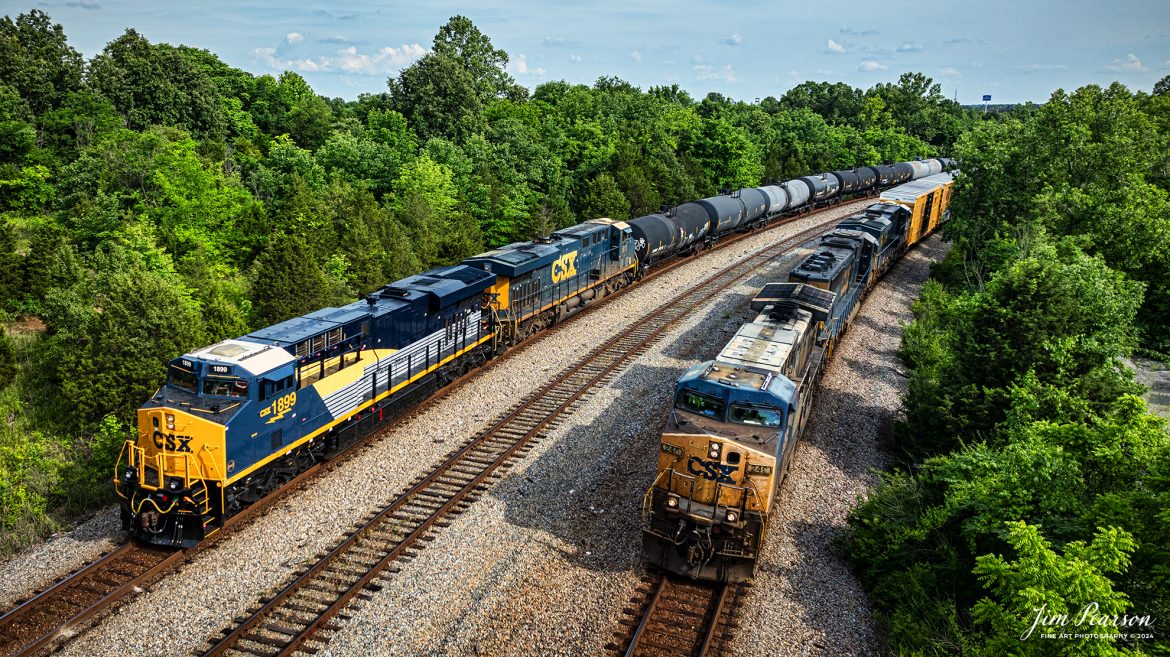 CSX M502 waits at Arklow in Madisonville, Ky with CSX Pere Marquette Heritage Unit, 1899, leading the way on the CSX Henderson Subdivision, on May 20th, 2024, as CSX M648 passes them heading north.

According to a CSX Press Release: May 1, 2024 - CSX has introduced the latest addition in its heritage locomotive series, paying homage to the rich history of the Pere Marquette Railroad. This new unit showcases the Pere Marquette's legacy, dating back to its inception on November 1, 1899.
 
The Pere Marquette Railroad, operating in the Great Lakes region of the United States and parts of southern Ontario, Canada, derived its name from Jacques Marquette, a notable French Jesuit missionary credited with founding Michigan's first European settlement in Sault Ste Marie. After years of operation, the company merged with the Chesapeake and Ohio Railway (C&O) on June 6, 1947, eventually becoming part of the renowned CSX network.
 
The design of the Pere Marquette heritage locomotive was meticulously crafted by employees at the CSX Waycross Locomotive Shop. According to CSX Carman Painter Eric Lee, “We had to measure each stripe precisely and position the words just right to ensure it captured the look of the original design. It took us about four days just to lay out the stripes before we could begin painting.”
 
A fascinating tidbit related to the history of Pere Marquette is its cameo in the 2004 film "The Polar Express." The steam locomotive Pere Marquette 1225 served as the inspiration for the train depicted in the movie, with audio recordings of the actual locomotive in operation featured in the film. Interestingly, the locomotive had been donated to Michigan State University and was exhibited near the university's football stadium. The author of "The Polar Express" book drew inspiration from seeing this locomotive on display during childhood, solidifying its place in popular culture.
 
CSX's dedication to honoring the history and significance of the Pere Marquette Railroad through this new locomotive underscores the company's commitment to preserving and celebrating the heritage of American railroads. Keep an eye out as this remarkable piece of history moves across the CSX network, bridging the past with the present.

Tech Info: DJI Mavic 3 Classic Drone, RAW, 22mm, f/2.8, 1/1600, ISO 140.

#railroad #railroads #train, #trains #railway #railway #steamtrains #railtransport #railroadengines #picturesoftrains #picturesofrailways #besttrainphotograph #bestphoto #photographyoftrains #steamtrainphotography #CSXPereMarquetteheritageunit #bestsoldpicture #JimPearsonPhotography #csxheritagelocomotive