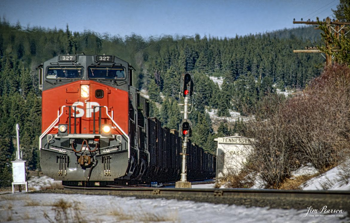 Southern Pacific locomotive 327 passes the signals in Tennessee Pass, Colorado, in this slide shot from the early 1990’s before Southern Pacific merged with Union Pacific.

According to the Southern Pacific History Center website, On February 1, 1997, Southern Pacific Transportation Company and the Union Pacific Railroad were formally merged. Union Pacific was merged into SPTC and the name was simultaneously changed from SPTC to the new Union Pacific Railroad.

According to Wikipedia: Tennessee Pass elevation is 10,424 ft (3,177 m) and is a high mountain pass in the Rocky Mountains of central Colorado in the United States. The pass was named after Tennessee, the native state of a group of early prospectors.


In 1996, UP bought Southern Pacific. UP preferred the Moffat Tunnel for routing traffic. The last revenue train went over the Tennessee Pass on August 23, 1997. Soon after UP ran this last train, UP applied to the Surface Transportation Board for permission to abandon the line.

The Royal Gorge Route Railroad currently offers scenic, tourist rail trips on 12 miles of the Tennessee Pass Line west of Cañon City. No freight has been shipped on the Tennessee Pass Line since 1997.

Union Pacific began actively discussing the sale of the line to Colorado Pacific in 2019, for an amount of $10 million. Colorado Pacific wanted to pay only the $8.8 million that the line was valued at. After a long battle in court, it was declared that they would not force a sale, but if other evidence was found, Colorado Pacific could re-file the report. As of October 2020, Colorado Pacific attempted another forced sale, this time saying they’ll run passenger/excursion service over the route. Union Pacific responded by stating they were in active negotiations for Rio Grande Pacific to operate the line and were opposed to Colorado Pacific's bid. On December 31, 2020, Rio Grande Pacific subsidiary Colorado, Midland & Pacific Railway Company, announced it had entered in an agreement with Union Pacific to explore reopening, leasing and operating the line for both potential commuter and freight services.

Tech Info: Nikon F3 Film Camera, exposure not recorded.

#railroad #railroads #train #trains #bestphoto #railroadengines #picturesoftrains #picturesofrailway #bestphotograph #photographyoftrains #trainphotography #JimPearsonPhotography #trending