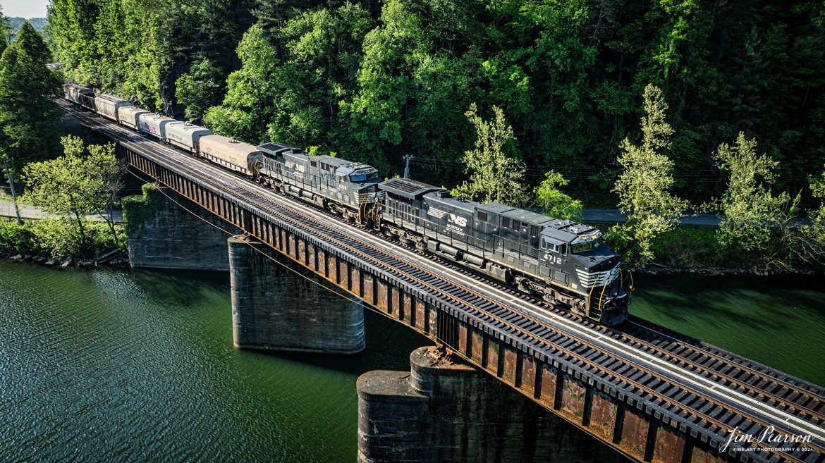 Norfolk Southern 178 crosses the Emory River at Harriman, TN, just south of Harriman Junction, on the NS CNO&TP (Rathole) Second District as it heads north on April 29th, 2024.

According to American-rails.com, It used to be called the Rathole Division when it was the Southern Railway and is often remembered as a road with relatively flat and tangent main lines due to the region in which it operated. However, the system did feature its share of steep, circuitous main lines such as Saluda Grade in western North Carolina and its famed “Rathole Division” through Kentucky and Tennessee that reached as far north as Cincinnati.

Technically, this stretch of the Southern main line was known as the 2nd District of subsidiary Cincinnati, New Orleans & Texas Pacific (CNO&TP), which was plagued for years by numerous tunnels resulting in its famous nickname by the crews which operated over it.

Over the years the Southern worked to daylight or bypass these obstacles as the route saw significant freight tonnage, a task finally completed during the 1960s. Today, the Rathole remains an important artery in Norfolk Southern’s vast network.

Tech Info: DJI Mavic 3 Classic Drone, RAW, 22mm, f/2.8, 1/1000, ISO 180.

#railroad #railroads #train #trains #bestphoto #railroadengines #picturesoftrains #picturesofrailway #bestphotograph #photographyoftrains #trainphotography #JimPearsonPhotography #nscnotpsubdivision #norfolksouthern #trendingphoto