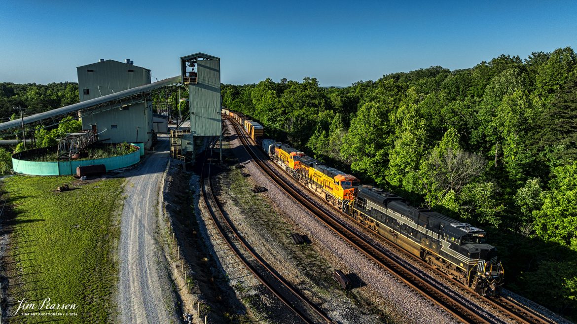 Norfolk Southern New York Central Heritage Unit, 1066, with BNSF 3809 and 7174 lead NS 167 past the old Southfork Coal Company mine loadout at Revelo outside Sterns, Kentucky as they head southbound with a mixed freight on the NS CNO&TP (Rathole) Subdivision, on June 7th, 2024. 

Tech Info: DJI Mavic 3 Classic Drone, RAW, 24mm, f/2.8, 1/1250, ISO 150.

#trainphotography #railroadphotography #trains #railways #trainphotographer #railroadphotographer #jimpearsonphotography #NSHeritageUnit #TennesseeTrains