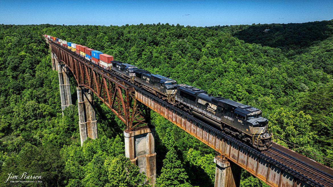 Norfolk Southern 1145 leads 178 as they make their way north across the New River Bridge on the NS CNO&TP (Rathole) Second District at New River, Tennessee. On June 7th, 2024.

According to the Historic Bridges website: This bridge is a very large high level deck cantilever truss bridge. It was constructed in 1963 and as such is a late example of its type, but still noteworthy as an uncommon structure type and for its size. Typical of 1960s truss bridges, the bridge still has riveted built-up beams, but v-lacing and lattice are absent in the built-up beams, and truss connections are bolted instead of riveted. It is 1,622.0 Feet (494.4 Meters) long, with 3 Main Span(s) and 6 Approach Span(s) is over 300 feet above the river.

Tech Info: DJI Mavic 3 Classic Drone, RAW, 22mm, f/2.8, 1/1600, ISO 130.

#trainphotography #railroadphotography #trains #railways #trainphotographer #railroadphotographer #jimpearsonphotography #NorfolkSouthern #TennesseeTrains