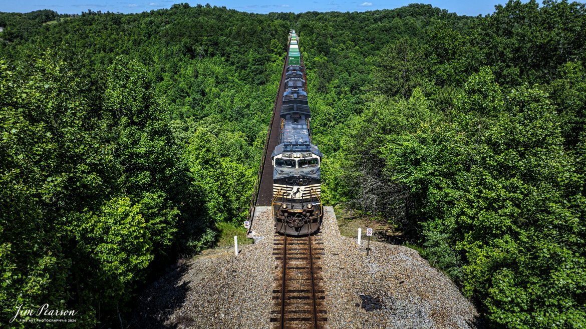 Norfolk Southern 9758 leads 29F as they make their way south across the New River Bridge on the NS CNO&TP (Rathole) Second District at New River, Tennessee. On June 7th, 2024.
According to the Historic Bridges website: This bridge is a very large high level deck cantilever truss bridge. It was constructed in 1963 and as such is a late example of its type, but still noteworthy as an uncommon structure type and for its size. Typical of 1960s truss bridges, the bridge still has riveted built-up beams, but v-lacing and lattice are absent in the built-up beams, and truss connections are bolted instead of riveted. It is 1,622.0 Feet (494.4 Meters) long, with 3 Main Span(s) and 6 Approach Span(s) is over 300 feet above the river.

Tech Info: DJI Mavic 3 Classic Drone, RAW, 22mm, f/2.8, 1/1000, ISO 100.

#trainphotography #railroadphotography #trains #railways #trainphotographer #railroadphotographer #jimpearsonphotography #NorfolkSouthern #TennesseeTrains