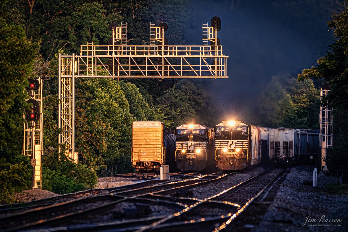 Norfolk Southern 168 passes 174 in the NS Yard at Burnside, Kentucky during the golden hour as it heads north on the NS CNO&TP (Rathole) Second District on June 7th, 2024.

According to American-rails.com, It used to be called the Rathole Division when it was the Southern Railway and is often remembered as a road with relatively flat and tangent main lines due to the region in which it operated. However, the system did feature its share of steep, circuitous main lines such as Saluda Grade in western North Carolina and its famed “Rathole Division” through Kentucky and Tennessee that reached as far north as Cincinnati.

Technically, this stretch of the Southern main line was known as the 2nd District of subsidiary Cincinnati, New Orleans & Texas Pacific (CNO&TP), which was plagued for years by numerous tunnels resulting in its famous nickname by the crews which operated over it.

Over the years the Southern worked to daylight or bypass these obstacles as the route saw significant freight tonnage, a task finally completed during the 1960s. Today, the Rathole remains an important artery in Norfolk Southern’s vast network.

Tech Info: Nikon D800, Sigma 150-600 @ 600mm, f/6.3, 1/200, ISO 450.

#trainphotography #railroadphotography #trains #railways #trainphotographer #railroadphotographer #jimpearsonphotography #NorfolkSouthern #KentuckyRailroads