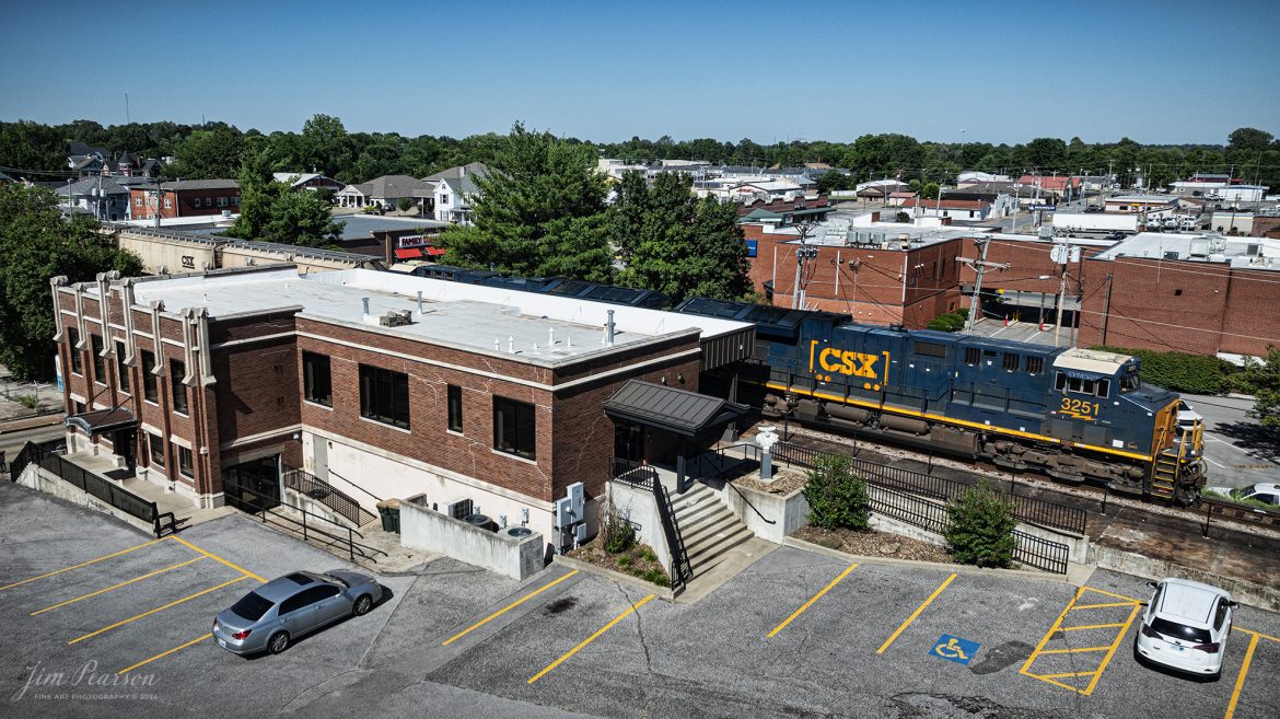 CSXT 3251 leads a southbound loaded grain train past the old Louisville and Nashville Railroad depot in downtown Madisonville, Kentucky, on June 13th, 2024, on the Henderson Subdivision. 

This depot was originally dedicated in 1929 and last saw passenger service about 1968 when L&N built an office at Atkinson Yard in Madisonville and the passenger train service was moved to that location. Currently the station is owned by the city of Madisonville and houses one of the hubs of the Kentucky Innovation Stations, which helps courageous entrepreneurs, creative business founders, high-growth startups, and savvy investors star in their own success stories.

Tech Info: DJI Mavic 3 Classic Drone, RAW, 22mm, f/2.8, 1/2500, ISO 100.

#railroad #railroads #train #trains #bestphoto #railroadengines #picturesoftrains #picturesofrailway #bestphotograph #photographyoftrains #trainphotography #JimPearsonPhotography #trendingphoto #csxt #trainsfromadrone