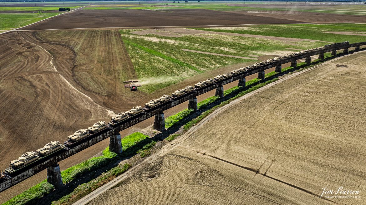 Farmers works on preparing their fields as CSX M512 heads north on the viaduct at Rahm, Indiana, on June 13th, 2024, with a string of 30 M1 Tanks in their consist as they head north on the CSX Henderson Subdivision. The viaduct here travels over a flood plain on the Ohio River.

Tech Info: DJI Mavic 3 Classic Drone, RAW, 22mm, f/2.8, 1/2500, ISO 110.

#railroad #railroads #train #trains #bestphoto #railroadengines #picturesoftrains #picturesofrailway #bestphotograph #photographyoftrains #trainphotography #JimPearsonPhotography #trendingphoto #csxt #trainsfromadrone #military