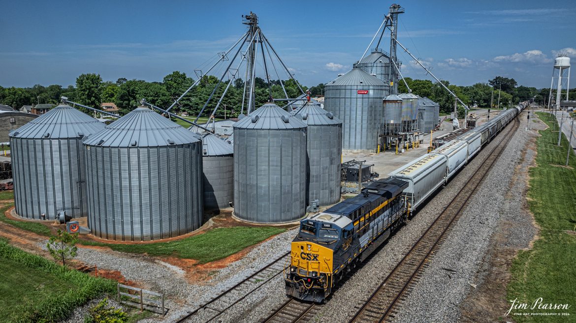 CSX Chesapeake and Ohio Heritage unit 1868 leads M503 as it heads south past the WF Ware Grain Facility at Trenton, Kentucky, on the Henderson Subdivision on the first day of summer, June 20th, 2024.

From a CSX Press Release: A locomotive commemorating the proud history of the Chesapeake and Ohio Railway has entered service as the fifth in the CSX heritage series celebrating the lines that came together to form the modern railroad.

Numbered CSX 1869 in honor of the year the C&O was formed in Virginia from several smaller railroads, the newest heritage locomotive sports a custom paint design that includes today’s CSX colors on the front of the engine and transitions to a paint scheme inspired by 1960s era C&O locomotives on the rear two-thirds.

The C&O Railway was a major line among North American freight and passenger railroads for nearly a century before becoming part of the Chessie System in 1972 and eventually merging into the modern CSX. In 1970, the C&O included more than 5,000 route miles of track stretching from Newport News, Virginia, to Chicago and the Great Lakes.

Tech Info: DJI Mavic 3 Classic Drone, RAW, 22mm, f/2.8, 1/2000, ISO 100.

#railroad #railroads #train #trains #bestphoto #railroadengines #picturesoftrains #picturesofrailway #bestphotograph #photographyoftrains #trainphotography #JimPearsonPhotography #trendingphoto #csxt #trainsfromadrone #csxheritage