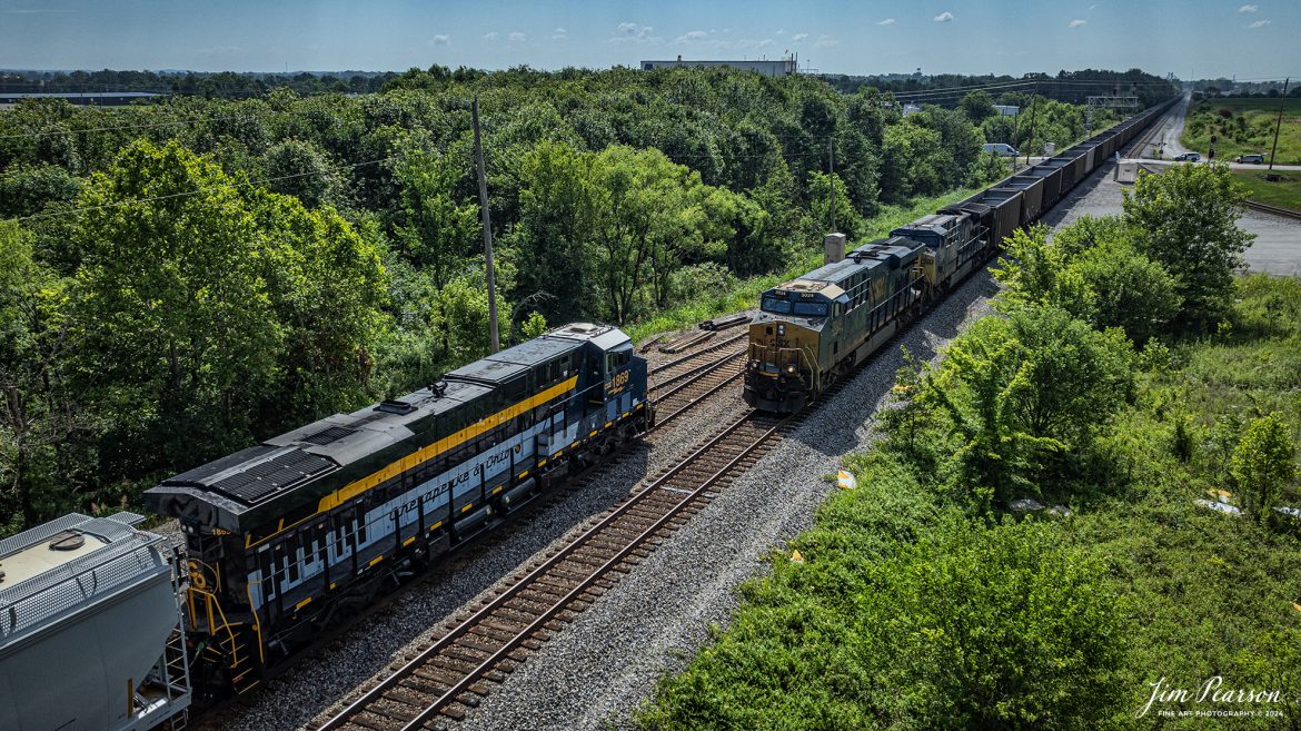 CSX Chesapeake and Ohio Heritage unit 1868 leads M503 as it meets northbound empty coal train E002 at the south end of the siding at Crofton, Kenucky on the Henderson Subdivision, on the first day of summer, June 20th, 2024.

From a CSX Press Release: A locomotive commemorating the proud history of the Chesapeake and Ohio Railway has entered service as the fifth in the CSX heritage series celebrating the lines that came together to form the modern railroad.

Numbered CSX 1869 in honor of the year the C&O was formed in Virginia from several smaller railroads, the newest heritage locomotive sports a custom paint design that includes today’s CSX colors on the front of the engine and transitions to a paint scheme inspired by 1960s era C&O locomotives on the rear two-thirds.

The C&O Railway was a major line among North American freight and passenger railroads for nearly a century before becoming part of the Chessie System in 1972 and eventually merging into the modern CSX. In 1970, the C&O included more than 5,000 route miles of track stretching from Newport News, Virginia, to Chicago and the Great Lakes.

Tech Info: DJI Mavic 3 Classic Drone, RAW, 22mm, f/2.8, 1/3200, ISO 150.

#railroad #railroads #train #trains #bestphoto #railroadengines #picturesoftrains #picturesofrailway #bestphotograph #photographyoftrains #trainphotography #JimPearsonPhotography #trendingphoto #csxt #trainsfromadrone #csxheritage