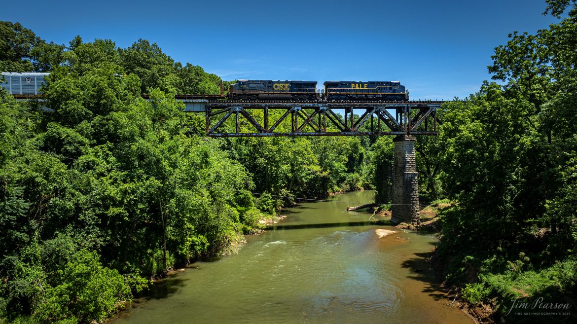 CSXT 1875, the P&LE Heritage Unit, leads CSX M513,  southbound on the subdivision, across the Red River Trestle at Adams, Tennessee on June 24th, 2024 along the CSX Henderson Subdivision. 

According to a CSX Press Release: June 6, 2024 - CSX has released a new heritage locomotive, the P&LE 1875, paying tribute to the storied Pittsburgh & Lake Erie Railroad (P&LE). The 15th in CSX’s heritage locomotive series, this new addition to the company’s fleet not only celebrates the rich history of P&LE but also marks a significant milestone in CSX's ongoing commitment to honoring the legacies of America's historic railroads.

The Pittsburgh & Lake Erie Railroad was established in 1875 with a primary mission of transporting essential industrial materials such as coal, coke, iron ore, limestone, and steel among the bustling industrial hubs of the region. 

“It’s mainline connected Pittsburgh, Pennsylvania with Youngstown, Ohio and Connellsville, Pennsylvania. It did not actually reach Lake Erie until 1976,” explained Tim Music, a carman painter at the CSX Waycross Locomotive Shop where the unit was produced.

Despite its relatively modest route mileage, the P&LE Railroad earned the nickname "Little Giant" due to the enormous volume of heavy tonnage it moved. This impressive capability drew significant attention and by 1887, the P&LE became a subsidiary of the dominant New York Central Railroad. Under this new ownership, the P&LE enjoyed substantial improvements to its tracks and added capacity for passenger services, further enhancing its regional significance.

Over time, P&LE expanded by leasing branches from smaller railroads. These extensions included lines southeast along the Monongahela River through Homestead and McKeesport, and along the Youghiogheny River to Connellsville, where it connected with the Western Maryland Railway.


Tech Info: DJI Mavic 3 Classic Drone, RAW, 22mm, f/2.8, 1/1250, ISO 120.

#railroad #railroads #train, #trains #railway #railway #steamtrains #railtransport #railroadengines #picturesoftrains #picturesofrailways #besttrainphotograph #bestphoto #photographyoftrains #steamtrainphotography #bestsoldpicture #JimPearsonPhotography