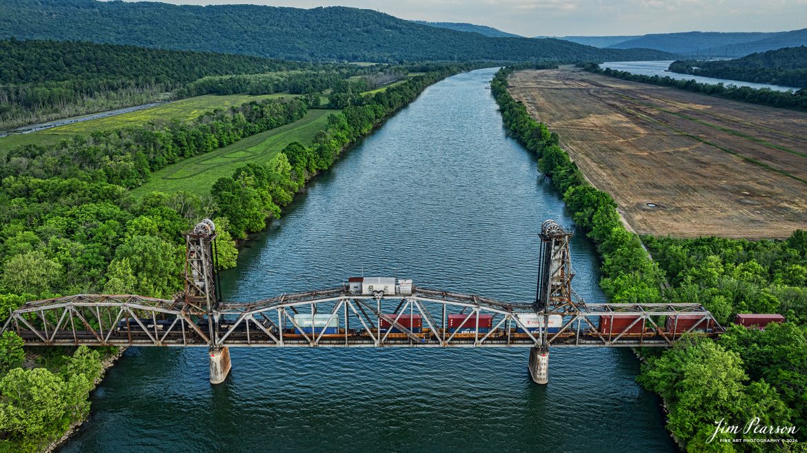 Norfolk Southern intermodal train crosses lift bridge over the Tennessee River on the CSX Chattanooga Subdivision, at Bridgeport, Alabama, as they make their way to the NS CNO&TP (Rathole) Second District and on north on April 26, 2024.

Tech Info: DJI Mavic 3 Classic Drone, RAW, 24mm, f/2.8, 1/500, ISO 150.