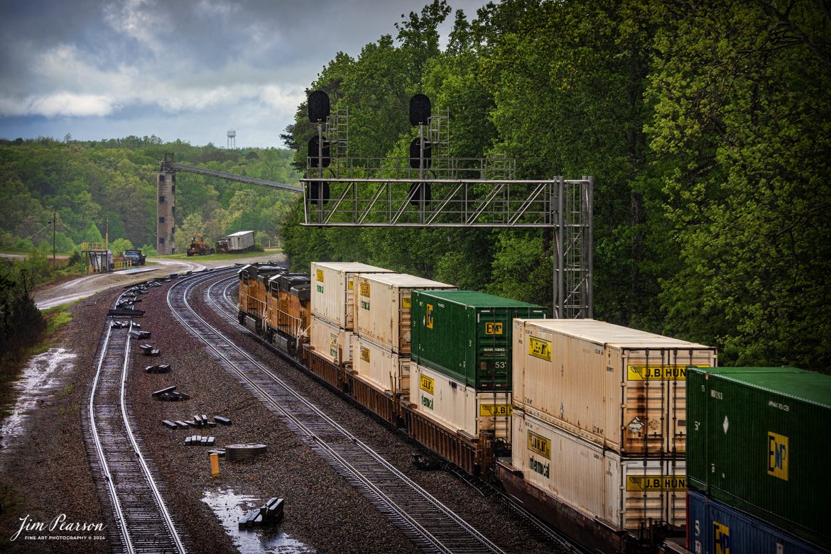 Union Pacific 5760 and 9788 lead Norfolk Southern 224 through the location known as Revilo, at Sterns, Ky, through a light rain as they head northbound on the CNO&TP 2nd District.

According to American-rails.com, It used to be called the Rathole Division when it was the Southern Railway and is often remembered as a road with relatively flat and tangent main lines due to the region in which it operated. However, the system did feature its share of steep, circuitous main lines such as Saluda Grade in western North Carolina and its famed “Rathole Division” through Kentucky and Tennessee that reached as far north as Cincinnati.

Technically, this stretch of the Southern main line was known as the 2nd District of subsidiary Cincinnati, New Orleans & Texas Pacific (CNO&TP), which was plagued for years by numerous tunnels resulting in its famous nickname by the crews which operated over it.

Over the years the Southern worked to daylight or bypass these obstacles as the route saw significant freight tonnage, a task finally completed during the 1960s. Today, the Rathole remains an important artery in Norfolk Southern’s vast network.

Tech Info: Nikon D810, RAW, Nikon 70-300 @ 95mm, f/5, 1/400, ISO 64.

#trainphotography #railroadphotography #trains #railways #trainphotographer #railroadphotographer #jimpearsonphotography #NikonD810 #NorfolkSouthern #UnionPacific