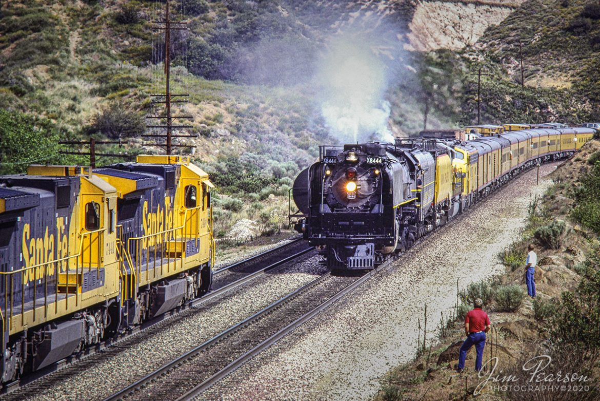 May 5, 1989 - The crew from a eastbound Santa Fe freight prepare to do a roll-by inspection on a passenger train being led by Union X8444 at Blue Cut in southern California's Cajon Pass on their way west to the 50th Anniversary Celebration of Los Angeles Union Station, with E-unit 951 trailing. This was the first Southern California appearance of a Union Pacific steam locomotive since 1956.

Tech Info: Nikon F3, Nikon 80-200mm, Kodachrome Slide, other data not recorded.

#railroad #railroads #train #trains #bestphoto #railroadengines #picturesoftrains #picturesofrailway #bestphotograph #photographyoftrains #trainphotography #JimPearsonPhotography #trendingphoto