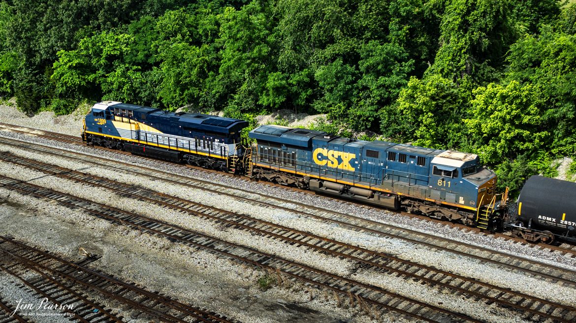 CSX M502 heads north from the south end of Atkinson Yard at Madisonville, Ky with CSX Pere Marquette Heritage Unit, 1899, leading the way on the CSX Henderson Subdivision, on May 20th, 2024.

According to a CSX Press Release: May 1, 2024 - CSX has introduced the latest addition in its heritage locomotive series, paying homage to the rich history of the Pere Marquette Railroad. This new unit showcases the Pere Marquette's legacy, dating back to its inception on November 1, 1899.
 
The Pere Marquette Railroad, operating in the Great Lakes region of the United States and parts of southern Ontario, Canada, derived its name from Jacques Marquette, a notable French Jesuit missionary credited with founding Michigan's first European settlement in Sault Ste Marie. After years of operation, the company merged with the Chesapeake and Ohio Railway (C&O) on June 6, 1947, eventually becoming part of the renowned CSX network.
 
The design of the Pere Marquette heritage locomotive was meticulously crafted by employees at the CSX Waycross Locomotive Shop. According to CSX Carman Painter Eric Lee, “We had to measure each stripe precisely and position the words just right to ensure it captured the look of the original design. It took us about four days just to lay out the stripes before we could begin painting.”
 
A fascinating tidbit related to the history of Pere Marquette is its cameo in the 2004 film "The Polar Express." The steam locomotive Pere Marquette 1225 served as the inspiration for the train depicted in the movie, with audio recordings of the actual locomotive in operation featured in the film. Interestingly, the locomotive had been donated to Michigan State University and was exhibited near the university's football stadium. The author of "The Polar Express" book drew inspiration from seeing this locomotive on display during childhood, solidifying its place in popular culture.
 
CSX's dedication to honoring the history and significance of the Pere Marquette Railroad through this new locomotive underscores the company's commitment to preserving and celebrating the heritage of American railroads. Keep an eye out as this remarkable piece of history moves across the CSX network, bridging the past with the present.

Tech Info: DJI Mavic 3 Classic Drone, RAW, 22mm, f/2.8, 1/1000, ISO 100.

#railroad #railroads #train, #trains #railway #railway #steamtrains #railtransport #railroadengines #picturesoftrains #picturesofrailways #besttrainphotograph #bestphoto #photographyoftrains #steamtrainphotography #CSXPereMarquetteheritageunit #bestsoldpicture #JimPearsonPhotography #csxheritagelocomotive