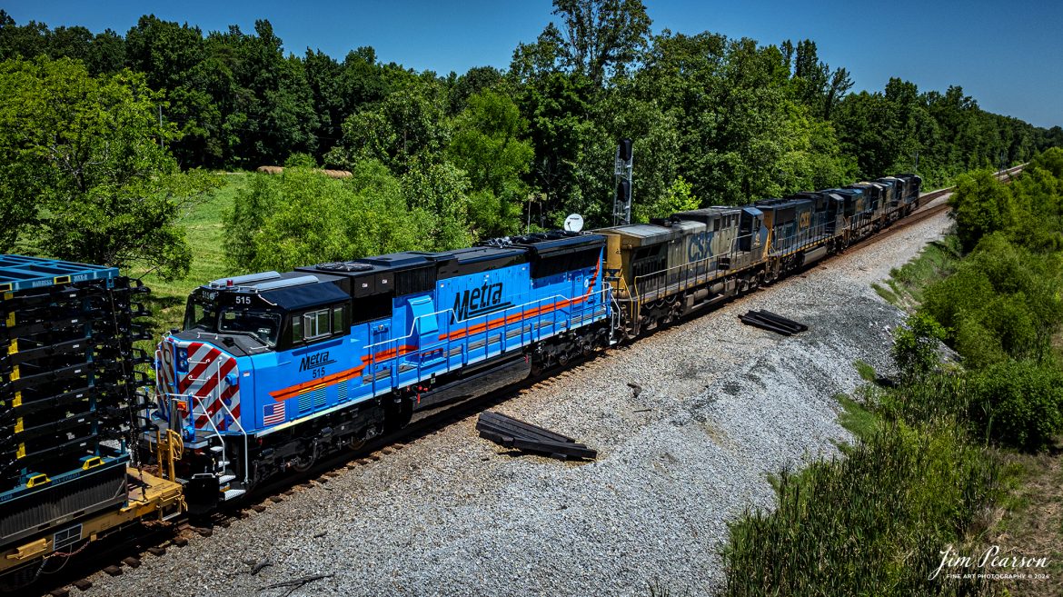 Metra 515 brings up the rear of a string of six units leading CSX M512 as they head north at Romney, Nortonville, Kentucky on their way north on June 27th, 2024, on the CSX Henderson Subdivision. Right behind the Metra unit is the start of a long string of Toyota Truck frames. 

I’m told that this is the first rebuilt ex-Kansas City unit by the Albertville, Ala.-based Progress Rail Services Corporation for Metra and part of an ongoing program and there are nine more being rebuilt numbered 515-523.

According to Wikipedia: Metra (reporting mark METX) is the primary commuter rail system in the Chicago metropolitan area serving the city of Chicago and its surrounding suburbs via the Union Pacific Railroad, BNSF Railway, and other railroads. The system operates 243 stations on 11 rail lines. It is the fourth busiest commuter rail system in the United States by ridership and the largest and busiest commuter rail system outside the New York City metropolitan area. In 2023, the system had a ridership of 31,894,900, or about 147,800 per weekday as of the first quarter of 2024. The estimated busiest day for Metra ridership occurred on November 4, 2016—the day of the Chicago Cubs 2016 World Series victory rally.

Metra is the descendant of numerous commuter rail services dating to the 1850s. The present system dates to 1974, when the Illinois General Assembly established the Regional Transportation Authority (RTA) to consolidate all public transit operations in the Chicago area, including commuter rail. The RTA's creation was a result of the anticipated failure of commuter service operated and owned by various private railroad companies in the 1970s. In a 1983 reorganization, the RTA placed commuter rail under a newly formed Commuter Rail Division, which branded itself as Metra in 1985. Freight rail companies still operate four of Metra's routes under purchase-of-service agreements. Metra owns all rolling stock and is responsible for all stations along with the respective municipalities. Since its inception, Metra has directed more than $5 billion into the commuter rail system of the Chicago metropolitan area alongside the CTA.

Tech Info: DJI Mavic 3 Classic Drone, RAW, 22mm, f/2.8, 1/2000, ISO 100.

#railroad #railroads #train #trains #bestphoto #railroadengines #picturesoftrains #picturesofrailway #bestphotograph #photographyoftrains #trainphotography #JimPearsonPhotography #trendingphoto #csxt #trainsfromadrone #metra