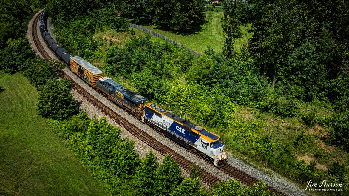 CSXT 4568, 50th Anniversary Operation Lifesaver locomotive, pulls a heavy M647 mixed freight as it passes through Nortonville, Ky on July 5th, 2024, on the CSX Henderson Subdivision.

According to a CSX press release: CSX unveiled a new Operation Lifesaver rail safety commemorative locomotive in September of 2022, and it was painted at the railroads locomotive shop in Huntington, West Virginia. The CSXT 4568 engine will travel the company’s rail network as a visual reminder for the public to be safe at highway-rail grade crossings and near railroad tracks.

Tech Info: DJI Mavic 3 Classic Drone, RAW, 22mm, f/2.8, 1/1250, ISO 100.

#railroad #railroads #train #trains #bestphoto #railroadengines #picturesoftrains #picturesofrailway #bestphotograph #photographyoftrains #trainphotography #JimPearsonPhotography #trendingphoto #csxt #trainsfromadrone #csxoperationlifesaver