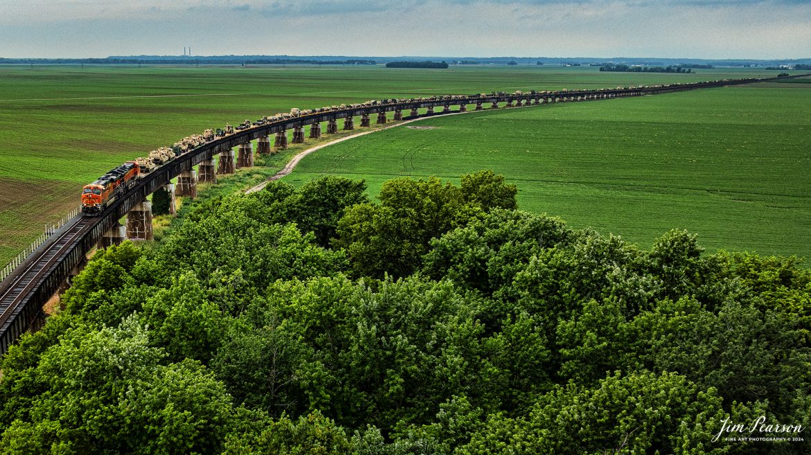 BNSF 6387 and 3947 lead a long CSX S577 up the viaduct at Rahm, Indiana where they will cross the Ohio River into Henderson, Kentucky with a loaded military train bound for Ft. Campbell on the CSX Henderson Subdivision on July 9th, 2024

Tech Info: DJI Mavic 3 Classic Drone, RAW, 22mm, f/2.8, 1/1600, ISO 140.

#railroad #railroads #train #trains #bestphoto #railroadengines #picturesoftrains #picturesofrailway #bestphotograph #photographyoftrains #trainphotography #JimPearsonPhotography #trendingphoto #militarytrains