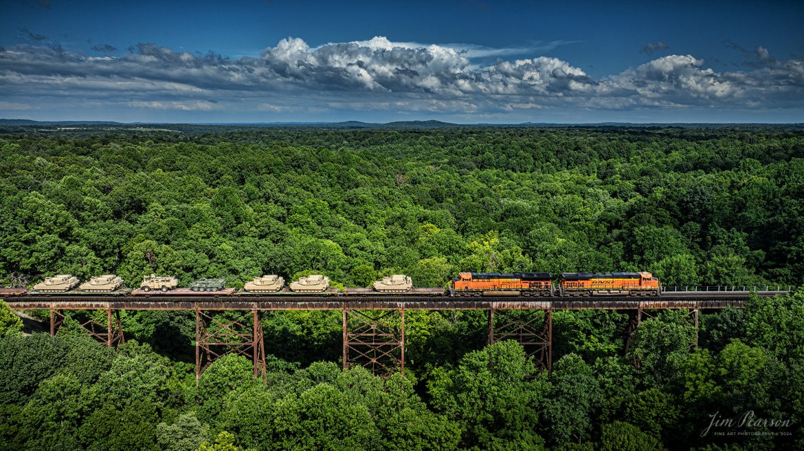 BNSF 6387 and 3947 lead CSX S577 heads south across Gum Lick Trestle, just north of Kelly, Kentucky with a loaded military train bound for Ft. Campbell on the CSX Henderson Subdivision on July 9th, 2024

Tech Info: DJI Mavic 3 Classic Drone, RAW, 22mm, f/2.8, 1/2000, ISO 110.

#railroad #railroads #train #trains #bestphoto #railroadengines #picturesoftrains #picturesofrailway #bestphotograph #photographyoftrains #trainphotography #JimPearsonPhotography #trendingphoto #militarytrains #bnsf