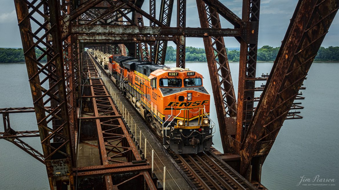 BNSF 6387 and 3947 lead CSX S577 across the Ohio River at Henderson, Kentucky with a loaded military train bound for Ft. Campbell on the CSX Henderson Subdivision on July 9th, 2024

Tech Info: DJI Mavic 3 Classic Drone, RAW, 22mm, f/2.8, 1/1600, ISO 190.

#railroad #railroads #train #trains #bestphoto #railroadengines #picturesoftrains #picturesofrailway #bestphotograph #photographyoftrains #trainphotography #JimPearsonPhotography #trendingphoto #militarytrains #stormyweather