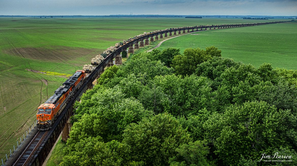 BNSF 6387 and 3947 lead CSX S577 up the viaduct at Rahm, Indiana where they will cross the Ohio River into Henderson, Kentucky with a loaded military train bound for Ft. Campbell on the CSX Henderson Subdivision on July 9th, 2024

Tech Info: DJI Mavic 3 Classic Drone, RAW, 22mm, f/2.8, 1/1600, ISO 140.

#railroad #railroads #train #trains #bestphoto #railroadengines #picturesoftrains #picturesofrailway #bestphotograph #photographyoftrains #trainphotography #JimPearsonPhotography #trendingphoto #militarytrains