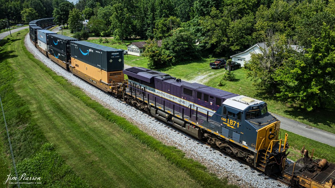 Atlantic Coast Line Heritage Unit CSXT 1871 runs as a mid-train DPU unit as it heads south through downtown Mortons Gap, Kentucky on July 12th, 2024, on the CSX Henderson Subdivision. This was my first catch on this heritage unit and while I would prefer it to be leading, I didn’t want to pass up a chance of catching this unit for my first time!

According to a CSX Press Release: November 29, 2023 - The CSX fleet of heritage locomotives is continuing to grow with the introduction of a unit painted in a custom design honoring the Atlantic Coast Line Railroad.

Designated CSX 1871, the seventh locomotive in the heritage series was unveiled at the CSX Locomotive Shop in Waycross, Georgia, which has designed and applied the paint schemes for all the heritage units. The latest in the series features the modern CSX design on the head end, transitioning to historic paint scheme and logo of the Atlantic Coast Line at the rear.

The Atlantic Coast Line name first appeared in 1871, and the American Coast Line Railroad (ACL) was officially incorporated in 1900. The ACL extended from Georgia to Richmond, Virginia, and later expanded into Florida. In 1960, the company opened a new headquarters building in Jacksonville, which continues as CSX headquarters to this day. The ACL merged with the Seaboard Air Line Railroad in 1967 to form the Seaboard Coast Line, which later became part of CSX.

“We do a lot of research on the colors and the schemes just to make sure that we get it right,” said Jeromy Hutchison, CSX carman painter. “We want to make sure we do our heritage justice.”

CSX 1871 will carry the ACL colors in service across the 20,000-mile CSX network, reinforcing employee pride in the history of the railroad that continues to move the nation’s economy with safe, reliable and sustainable rail-based transportation services.

Tech Info: DJI Mavic 3 Classic Drone, RAW, 22mm, f/2.8, 1/1600, ISO 100.

#railroad #railroads #train #trains #bestphoto #railroadengines #picturesoftrains #picturesofrailway #bestphotograph #photographyoftrains #trainphotography #JimPearsonPhotography #trendingphoto #csxheritagelocomotive #AtlanticCoasLine