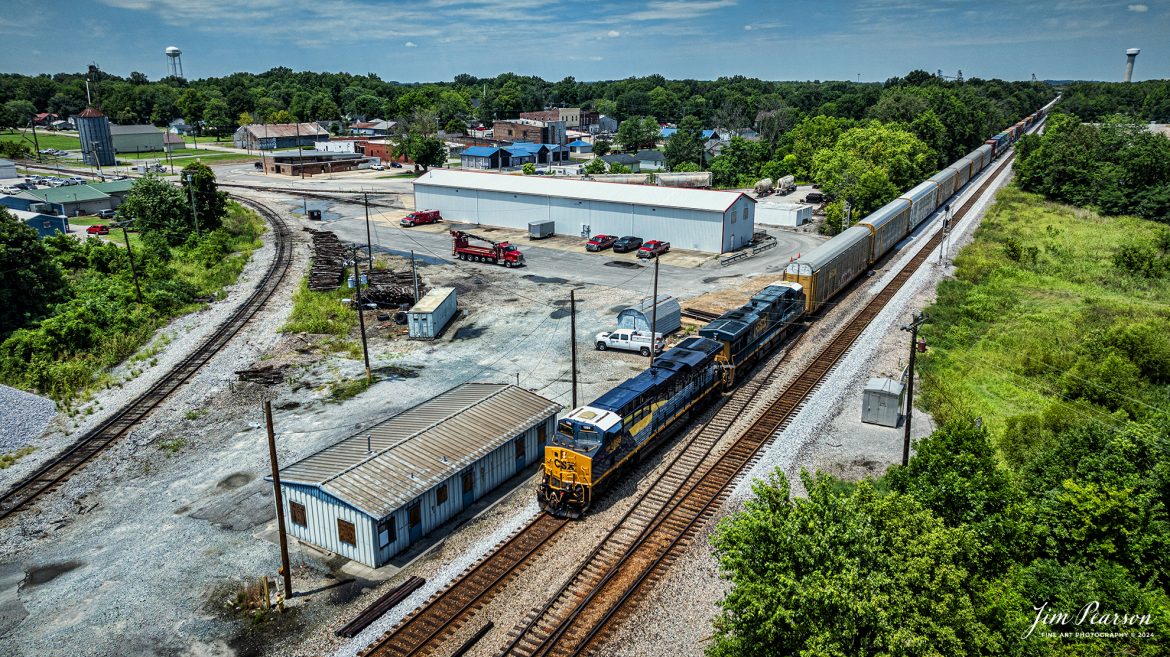 CSX I025 heads southbound with CSX Pere Marquette Heritage Unit 1899, leading the way on the CSX Henderson Subdivision, as they pass the CSX Yard office at Guthrie, Kentucky, on July 18th, 2024. 

According to a CSX Press Release: May 1, 2024 - CSX has introduced the latest addition in its heritage locomotive series, paying homage to the rich history of the Pere Marquette Railroad. This new unit showcases the Pere Marquette's legacy, dating back to its inception on November 1, 1899.
 
The Pere Marquette Railroad, operating in the Great Lakes region of the United States and parts of southern Ontario, Canada, derived its name from Jacques Marquette, a notable French Jesuit missionary credited with founding Michigan's first European settlement in Sault Ste Marie. After years of operation, the company merged with the Chesapeake and Ohio Railway (C&O) on June 6, 1947, eventually becoming part of the renowned CSX network.
 
The design of the Pere Marquette heritage locomotive was meticulously crafted by employees at the CSX Waycross Locomotive Shop. According to CSX Carman Painter Eric Lee, “We had to measure each stripe precisely and position the words just right to ensure it captured the look of the original design. It took us about four days just to lay out the stripes before we could begin painting.”
 
A fascinating tidbit related to the history of Pere Marquette is its cameo in the 2004 film "The Polar Express." The steam locomotive Pere Marquette 1225 served as the inspiration for the train depicted in the movie, with audio recordings of the actual locomotive in operation featured in the film. Interestingly, the locomotive had been donated to Michigan State University and was exhibited near the university's football stadium. The author of "The Polar Express" book drew inspiration from seeing this locomotive on display during childhood, solidifying its place in popular culture.
 
CSX's dedication to honoring the history and significance of the Pere Marquette Railroad through this new locomotive underscores the company's commitment to preserving and celebrating the heritage of American railroads. Keep an eye out as this remarkable piece of history moves across the CSX network, bridging the past with the present.

Tech Info: DJI Mavic 3 Classic Drone, RAW, 22mm, f/2.8, 1/2000, ISO 100.

#railroad #railroads #train, #trains #railway #railway #steamtrains #railtransport #railroadengines #picturesoftrains #picturesofrailways #besttrainphotograph #bestphoto #photographyoftrains #steamtrainphotography #CSXPereMarquetteheritageunit #bestsoldpicture #JimPearsonPhotography #csxheritagelocomotive